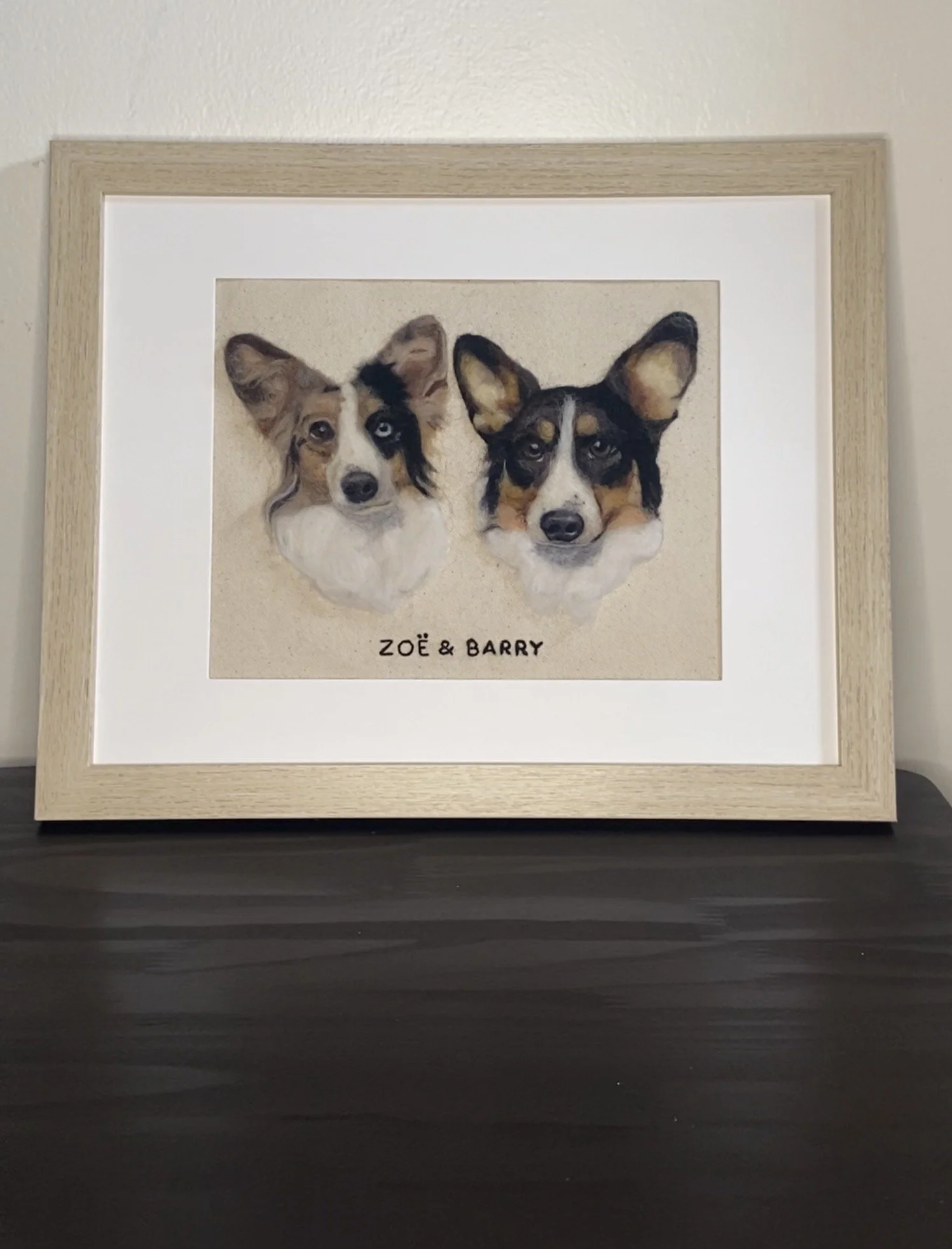 Framed watercolor painting of two dog's heads with the words "Zoë & Barry" written below.
