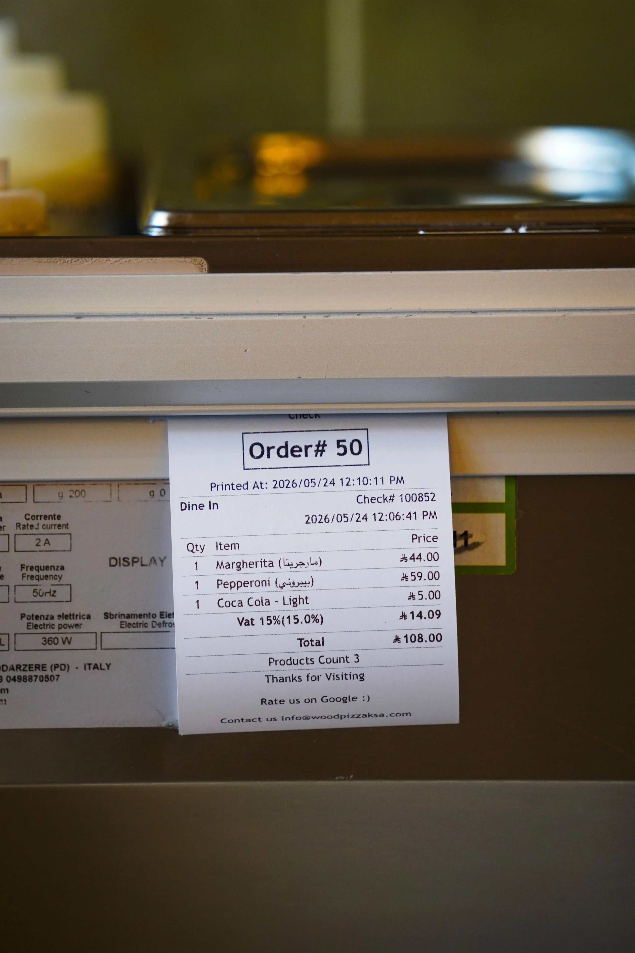 A receipt for a pizza order showing the items, prices, and total amount.