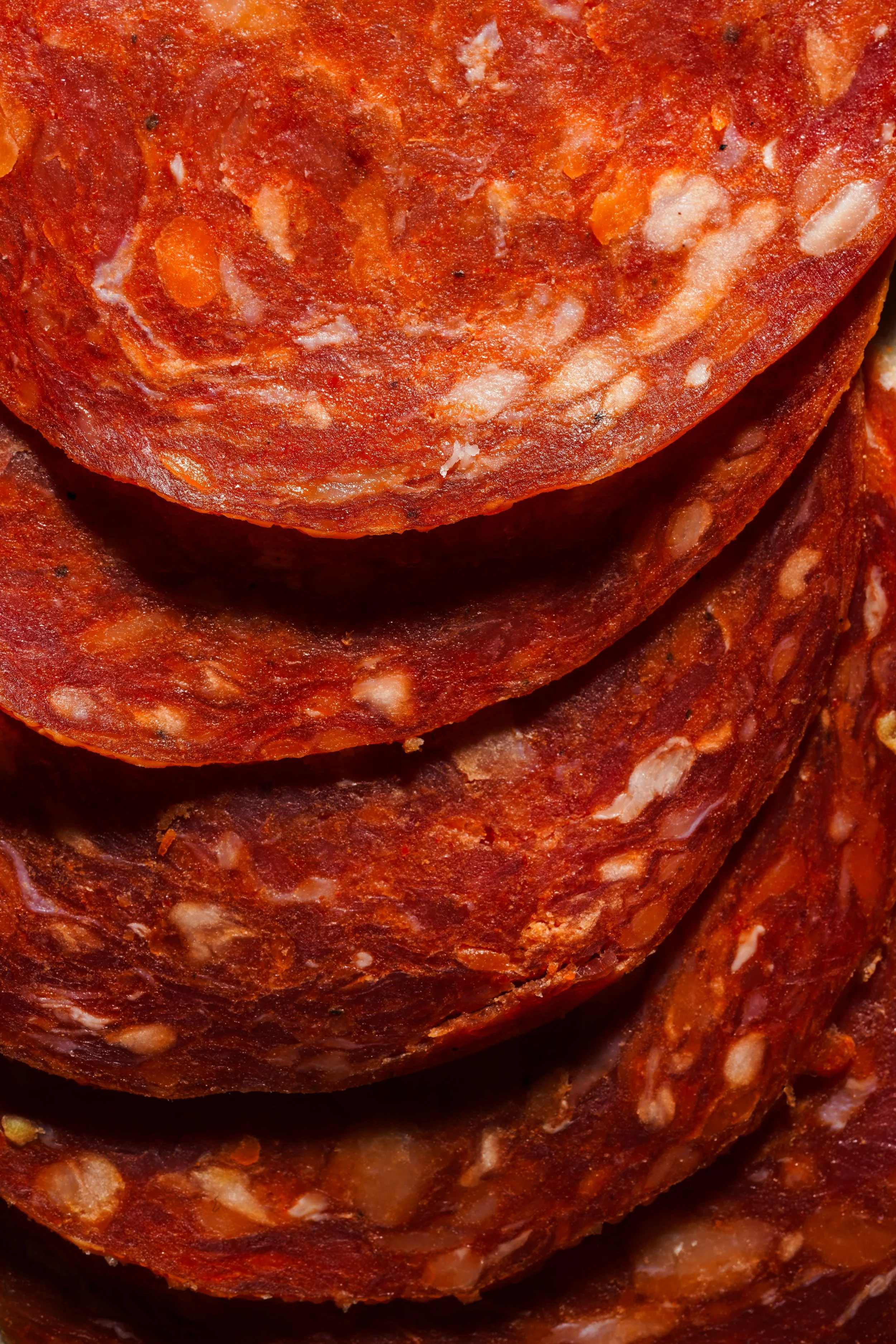 Close-up of stacked slices of pepperoni sausage