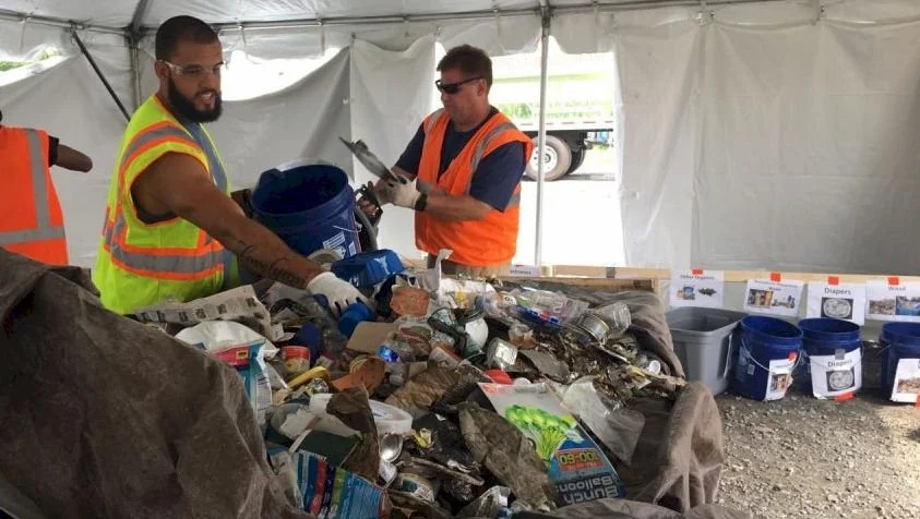 Workers sorting a waste sample during a material assessment