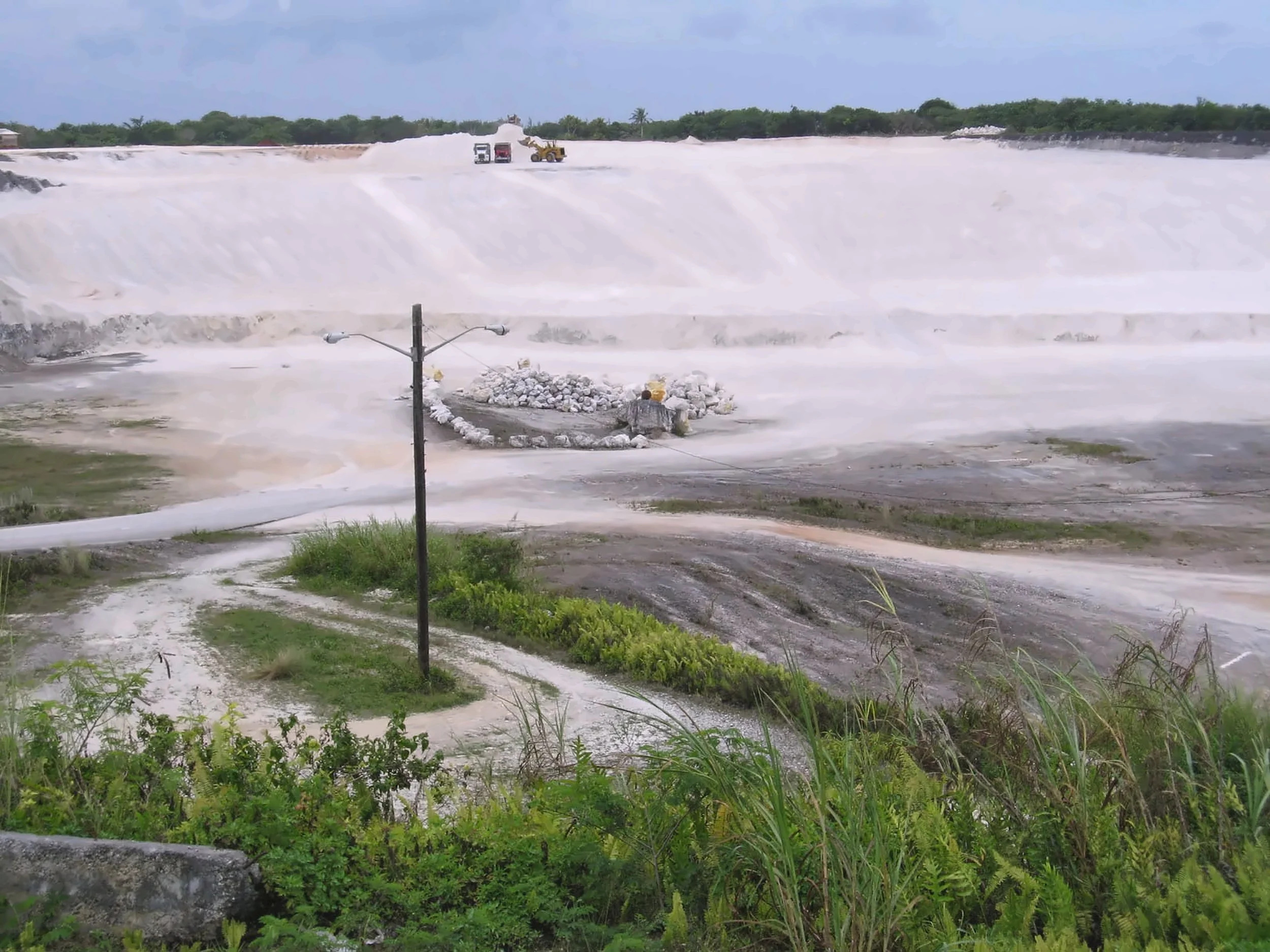 Wide view of crushed coral cover being placed over the Ordot Dump during closure