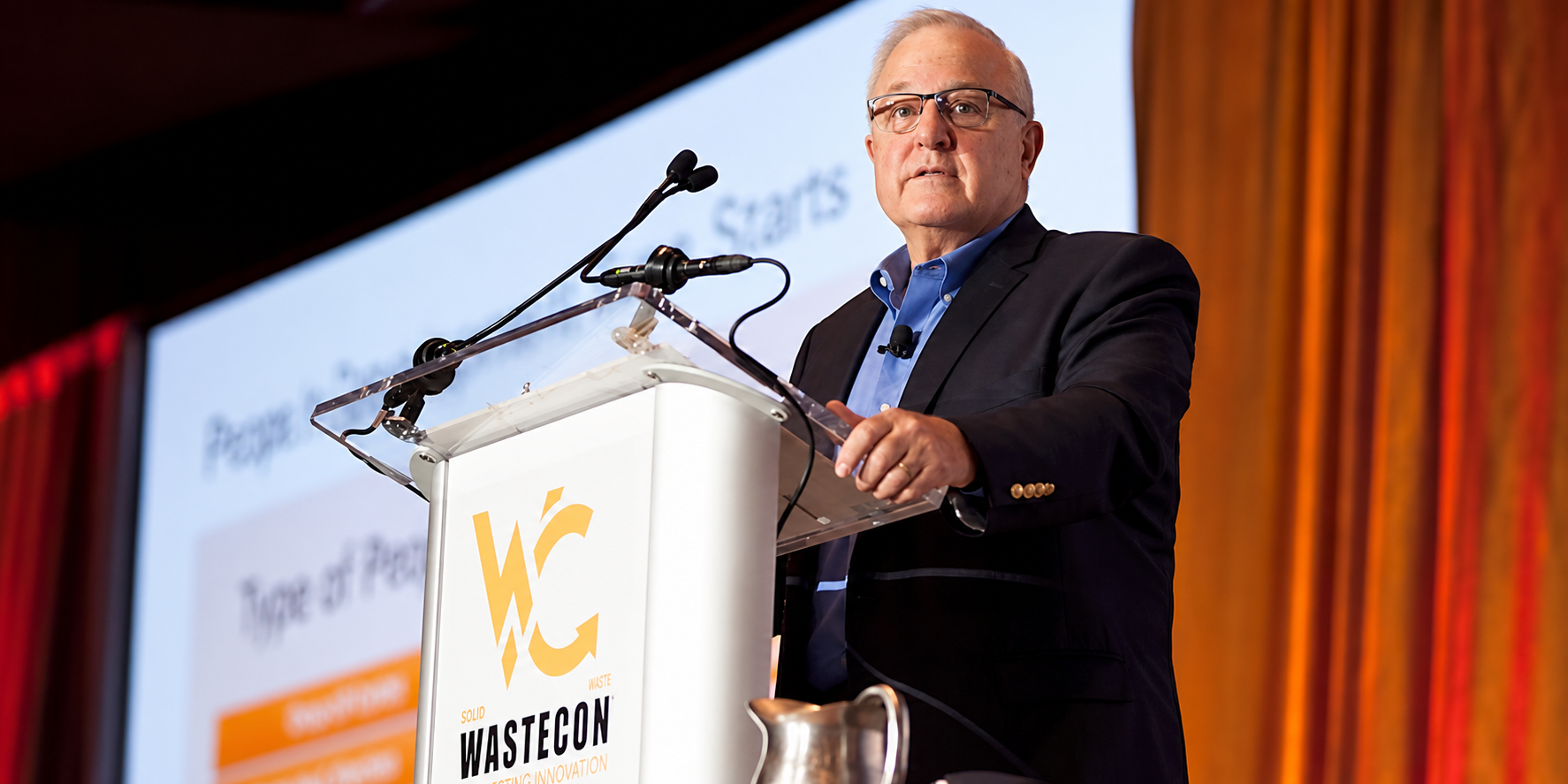 Harvey W. Gershman presenting at a WASTECON conference podium