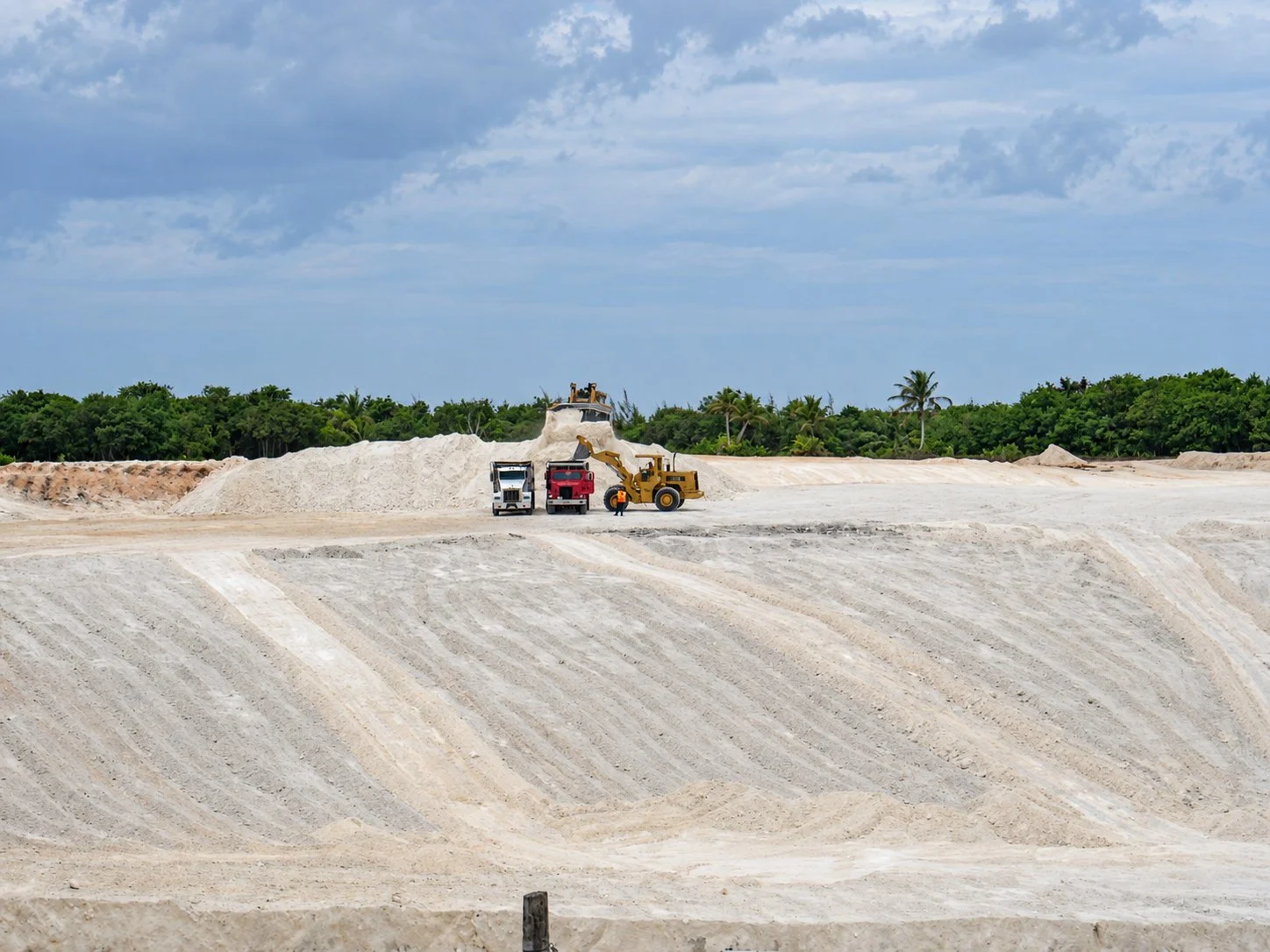 Trucks delivering crushed coral cover material at the Ordot Dump