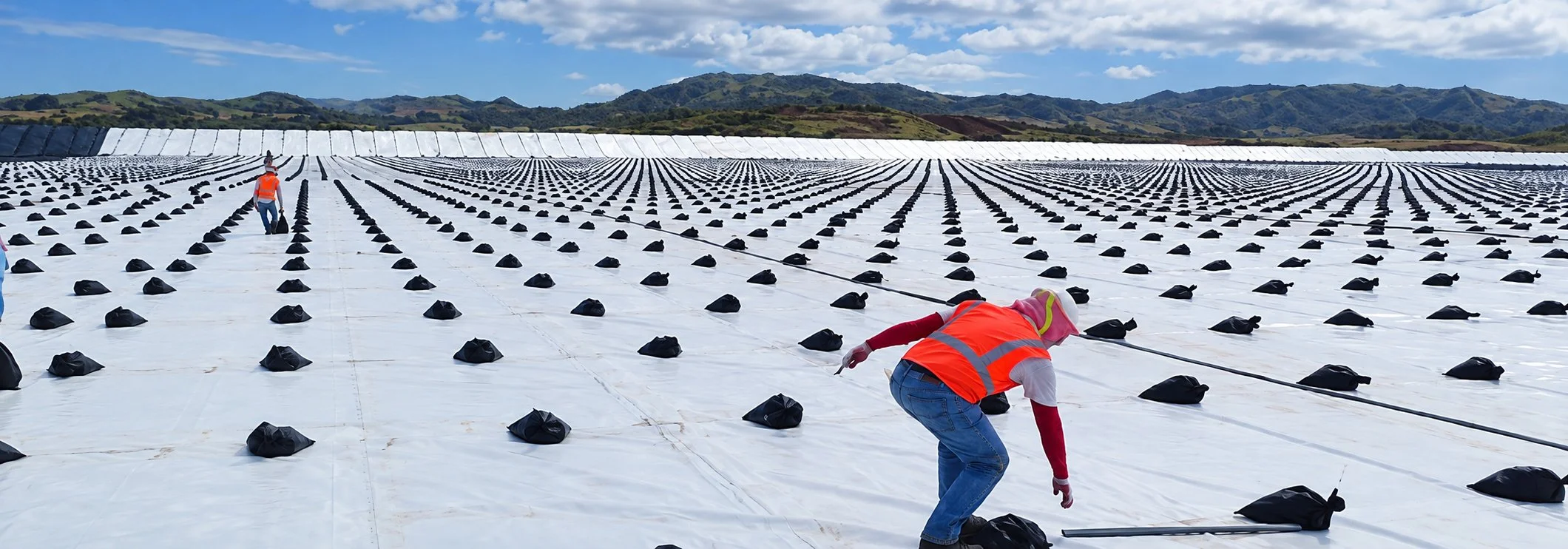 Sandbagged liner across the new landfill cell at Layon, Guam
