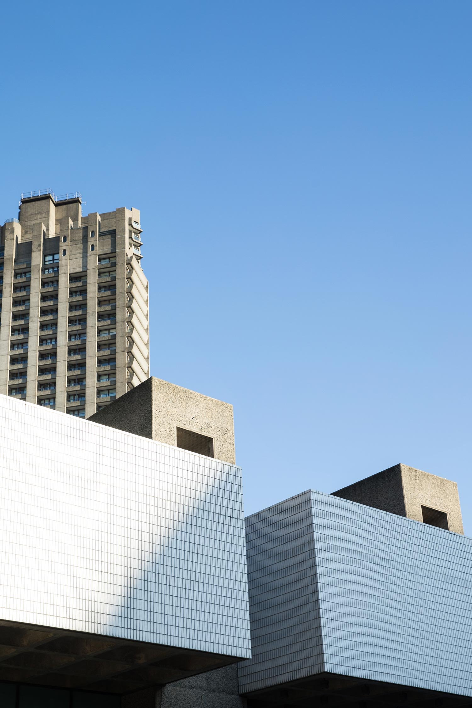 Vertical concrete structure at The Barbican framed against the sky.