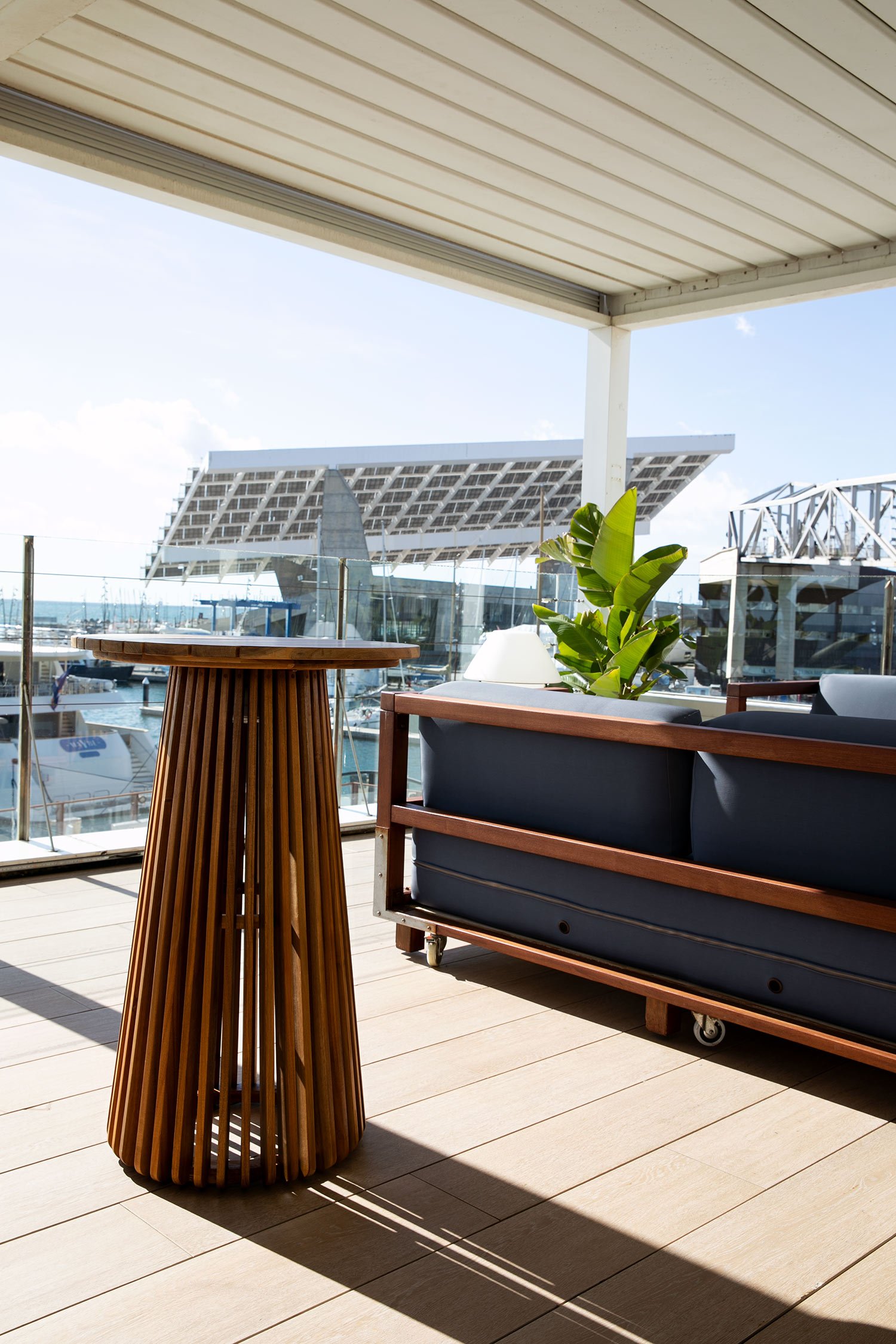 Blue upholstered sofa and sculptural wooden table in the waterfront lounge.
