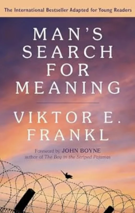 Book cover of 'Man's Search for Meaning' by Viktor E. Frankl with a sunset sky background, barbed wire at the bottom, and a bird flying.