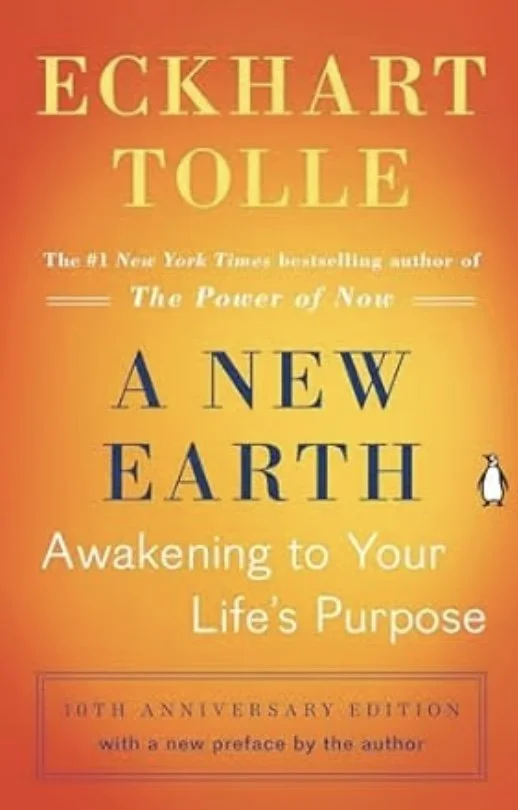 Book cover of 'A New Earth: Awakening to Your Life's Purpose' by Eckhart Tolle, 10th anniversary edition, featuring a warm orange and yellow gradient background and a small penguin illustration.