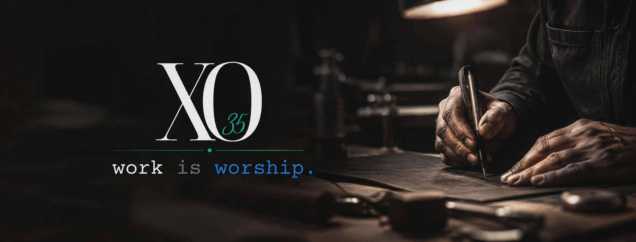 Close-up of a person with dark skin writing on leather with a silver pen; text overlay: "XO 35 work is worship".