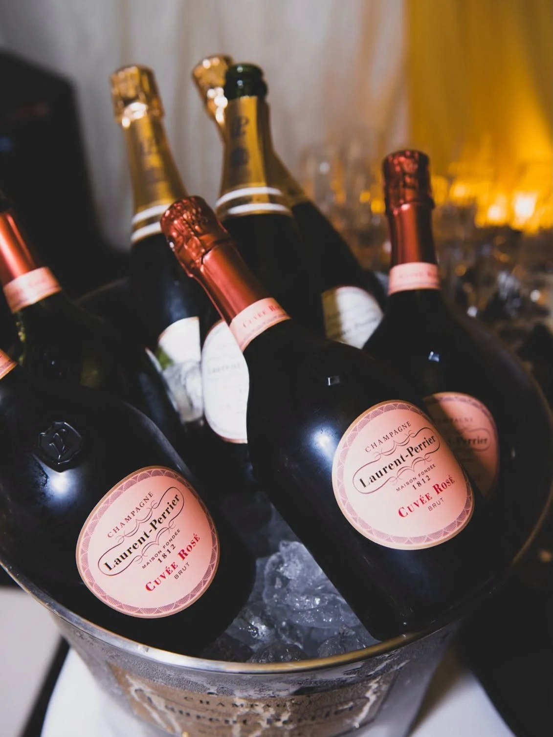Bottles of rosé champagne chilling in an ice bucket