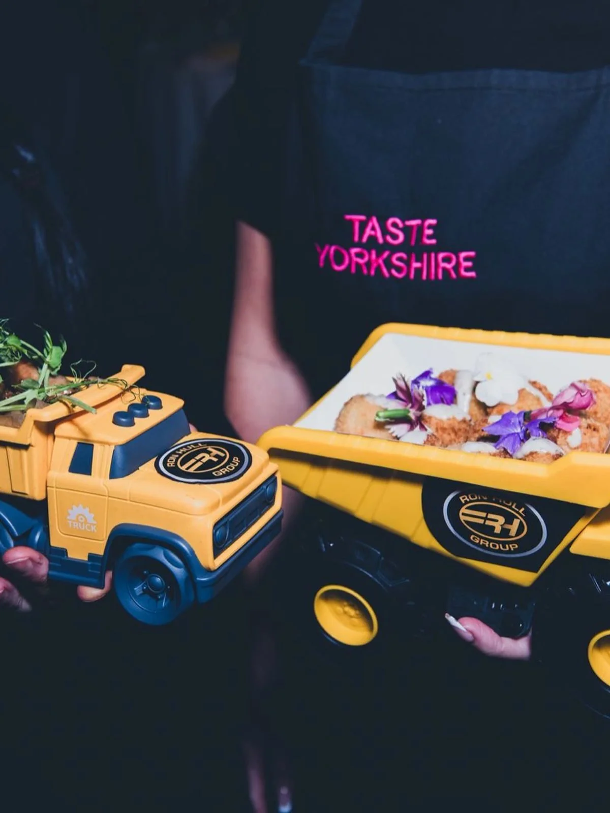Canapés served in toy dumper trucks branded with the Ron Hull Group logo
