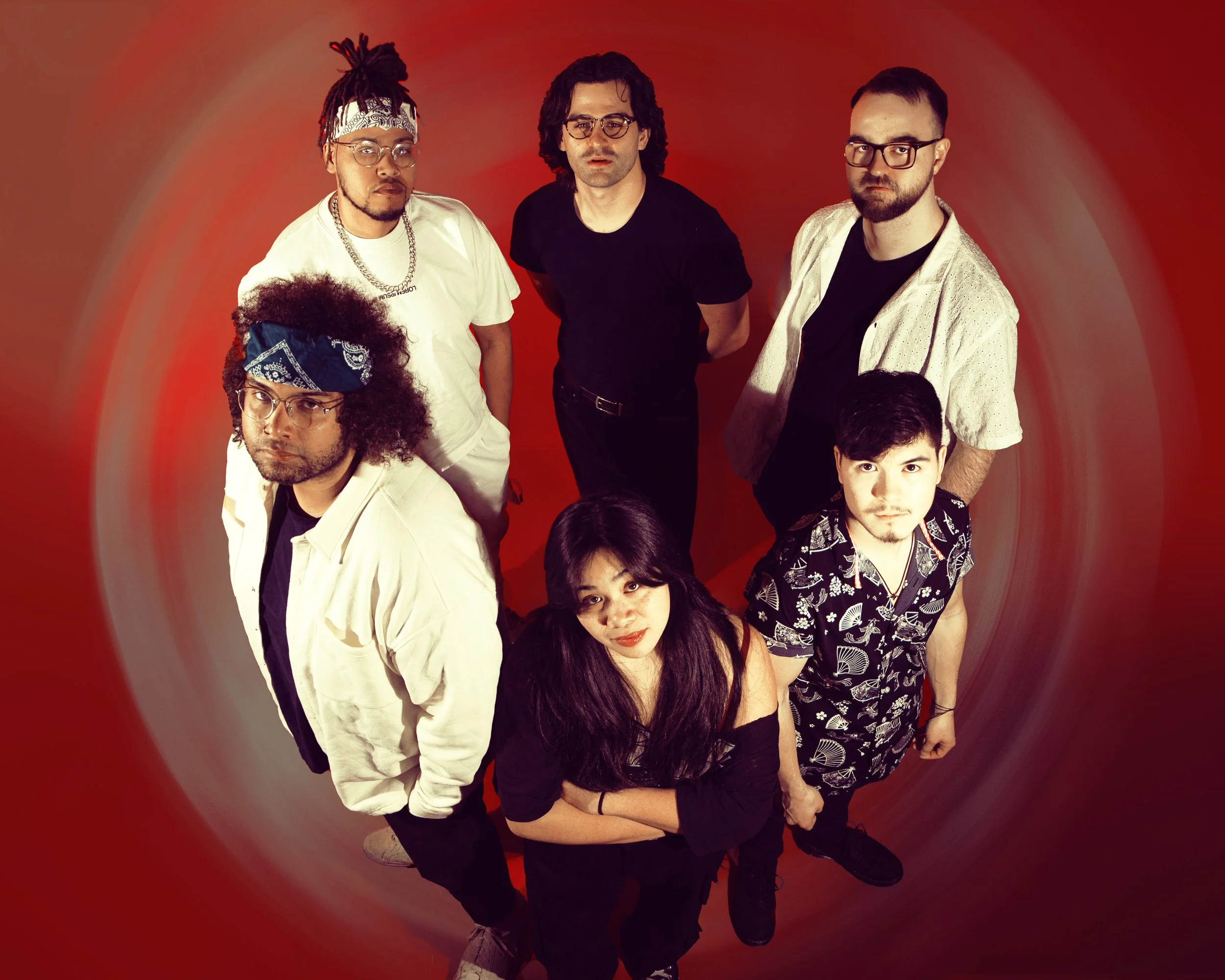 Local Dallas, Texas, DFW Non-traditional Fashion Editorial Creative Portraits Cover Art Photographer Photoshoot. Musicians band Cherry Mantis . Group of diverse young adults standing against a red background, looking at the camera.