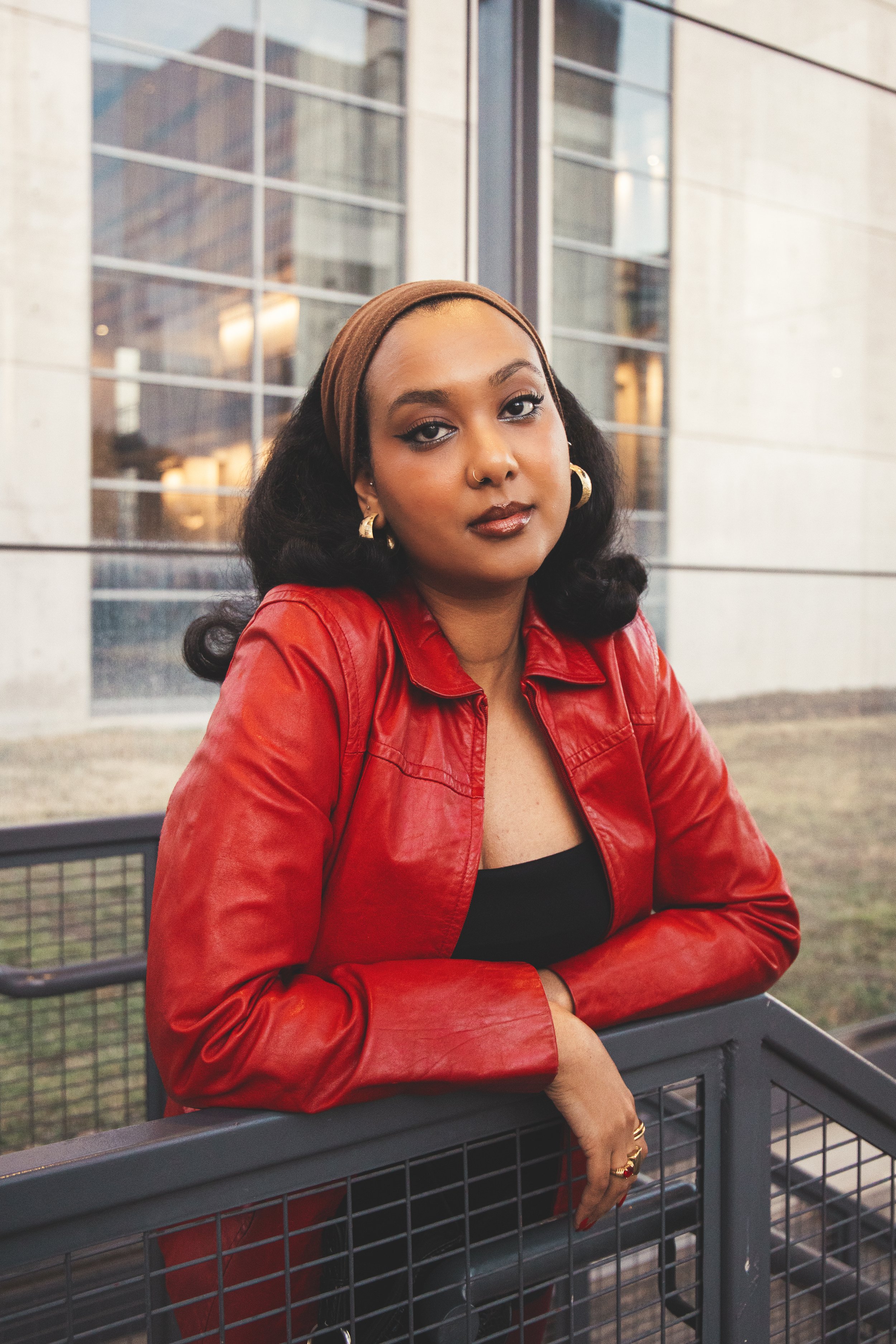 Local Dallas, Texas, DFW Non-traditional Fashion Editorial Creative Portraits Cover Art Photographer Photoshoot. A woman with dark curly hair wearing a brown headband, gold hoop earrings, a nose ring, and a gold ring on her index finger, dressed in a