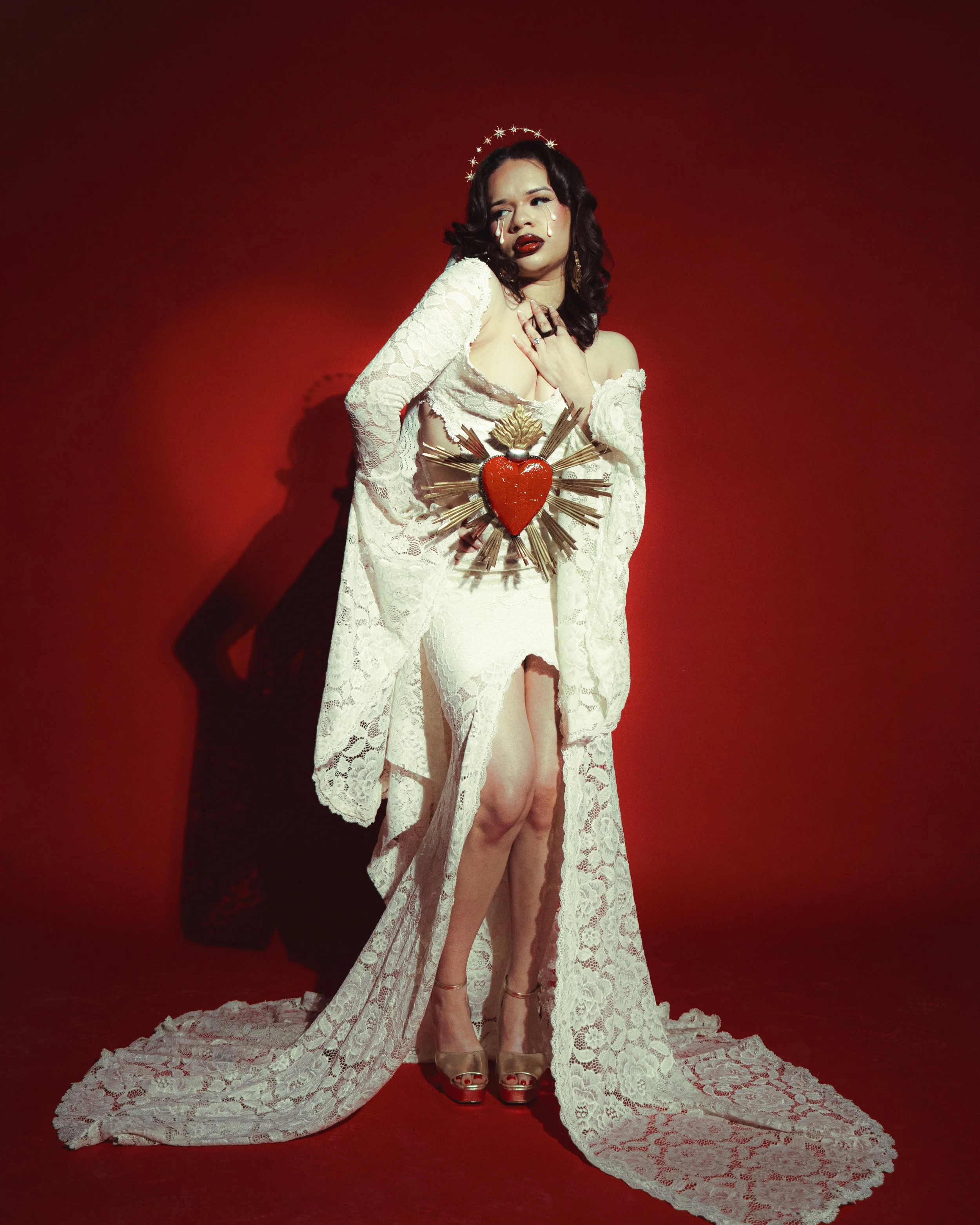 Local Dallas, Texas, DFW Non-traditional Fashion Editorial Creative Portraits Cover Art Photographer Photoshoot. @roseypears . A woman with dark hair in curls, wearing red lipstick and tears on her face, dressed in a white lace revealing gown with lo