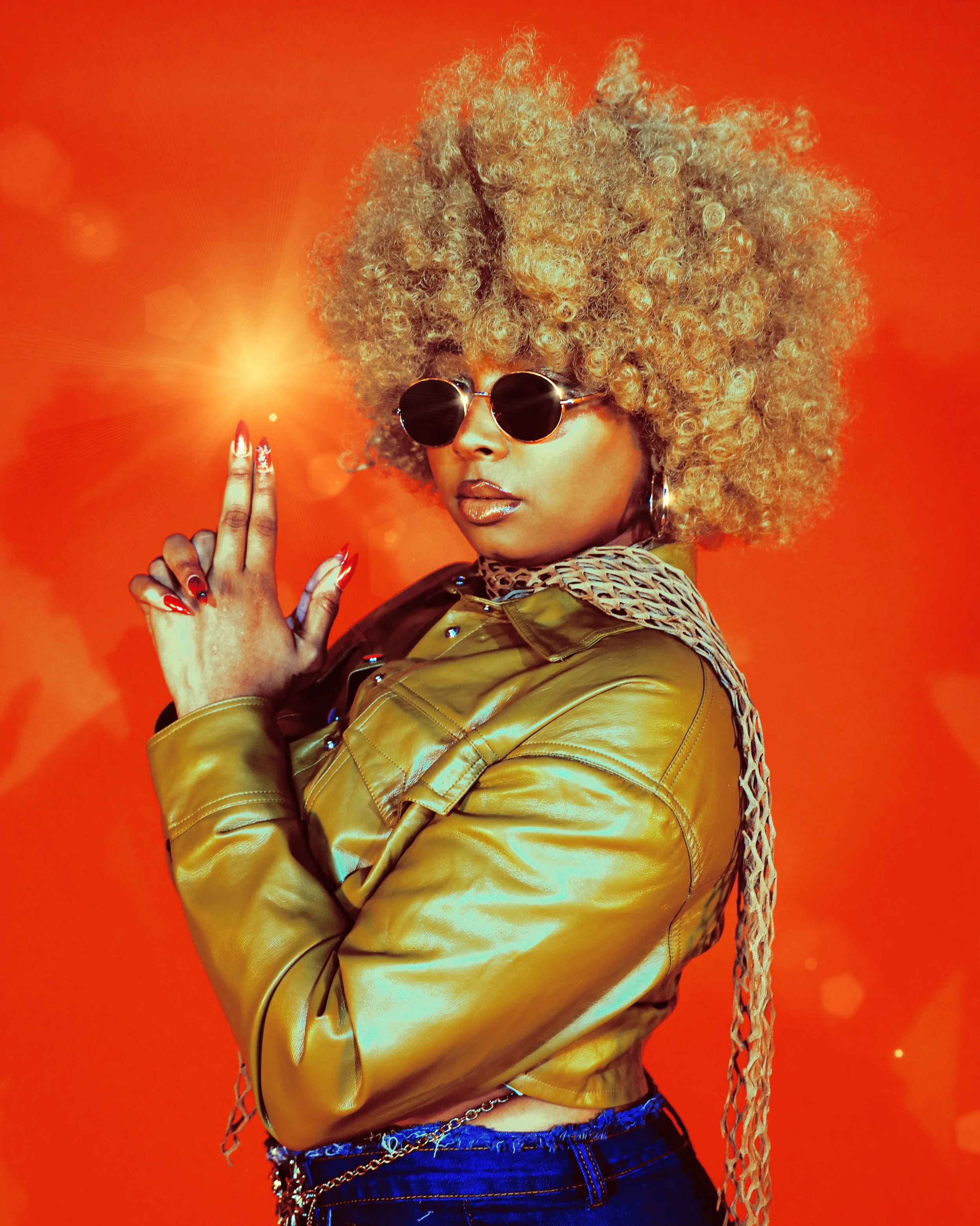 Local Dallas, Texas, DFW Non-traditional Editorial Creative Portraits Cover Art Photographer. Foxy Cleopatra .Local Dallas, Texas musician @Seiharaa with a curly blonde afro hairstyle wearing black sunglasses, a gold leather jacket, and a leopard pri
