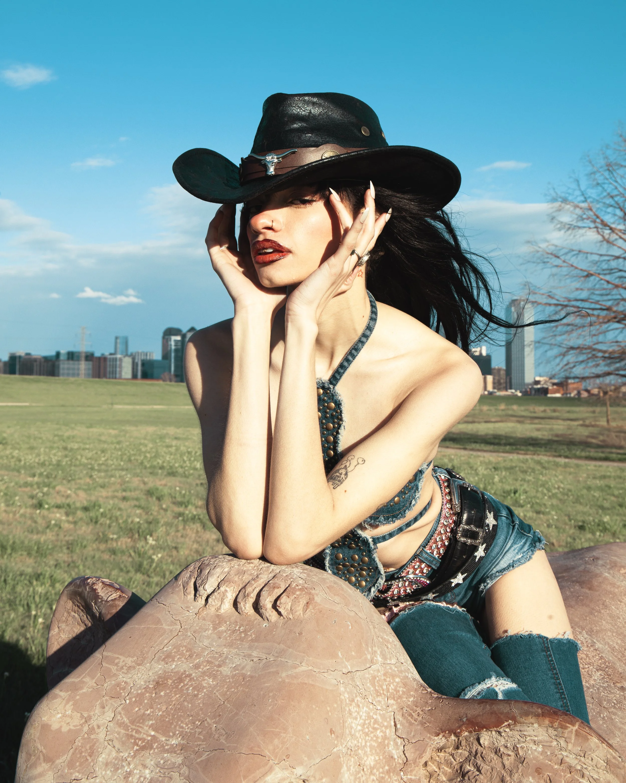 Local Dallas, Texas, DFW Non-traditional Fashion Editorial Creative Portraits Cover Art Photographer Photoshoot. Model @Namickaa . Trammell Crow Park.  woman with black hair, red lipstick, and tattoos, wearing a black cowboy hat with silver details, 