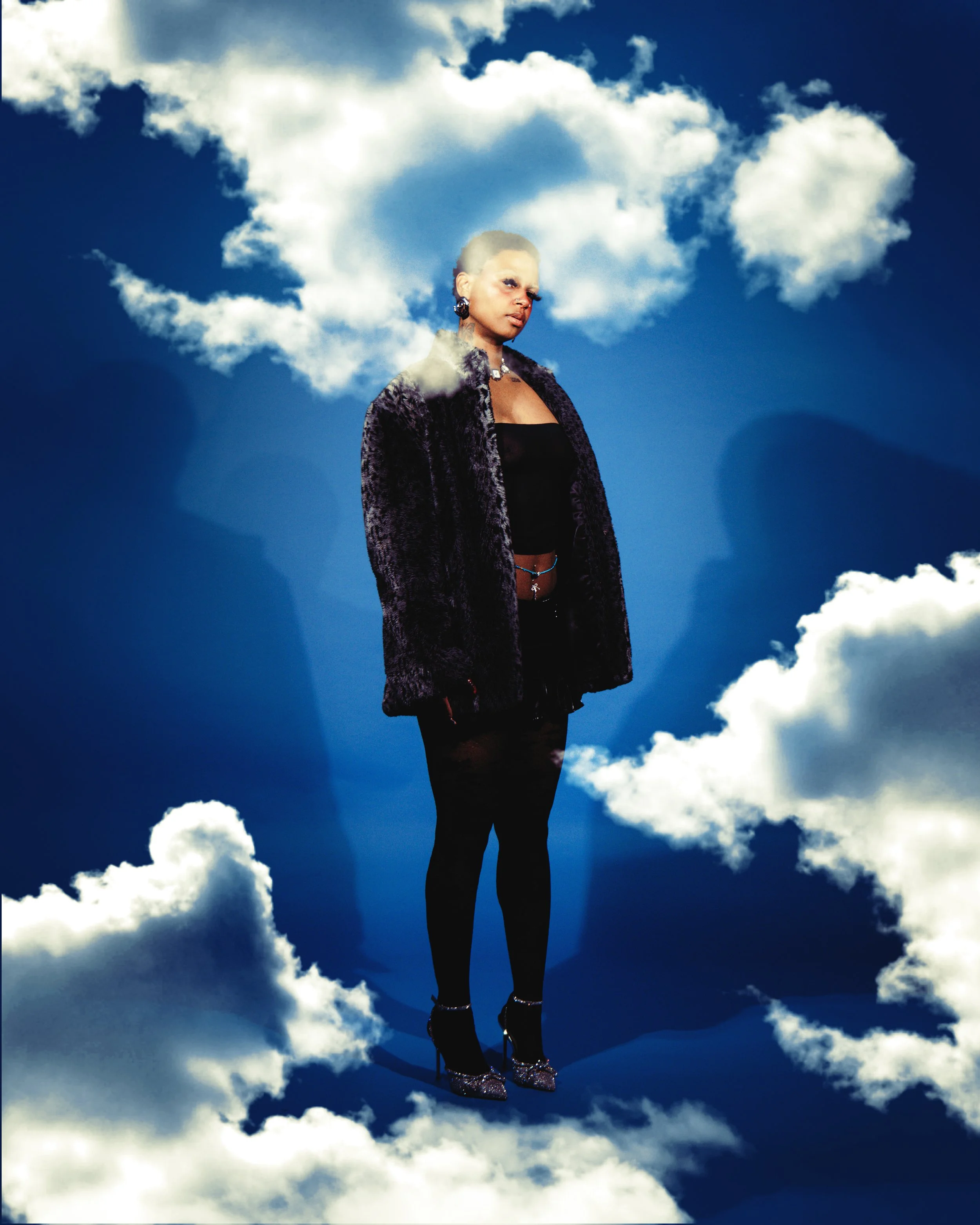 Local Dallas, Texas, DFW Non-traditional Editorial Creative Portraits Cover Art Photographer. @tunebbyworld. A person standing among clouds in the sky, wearing a dark fur coat, black top, black pants, and high-heeled shoes, with a serious expression 