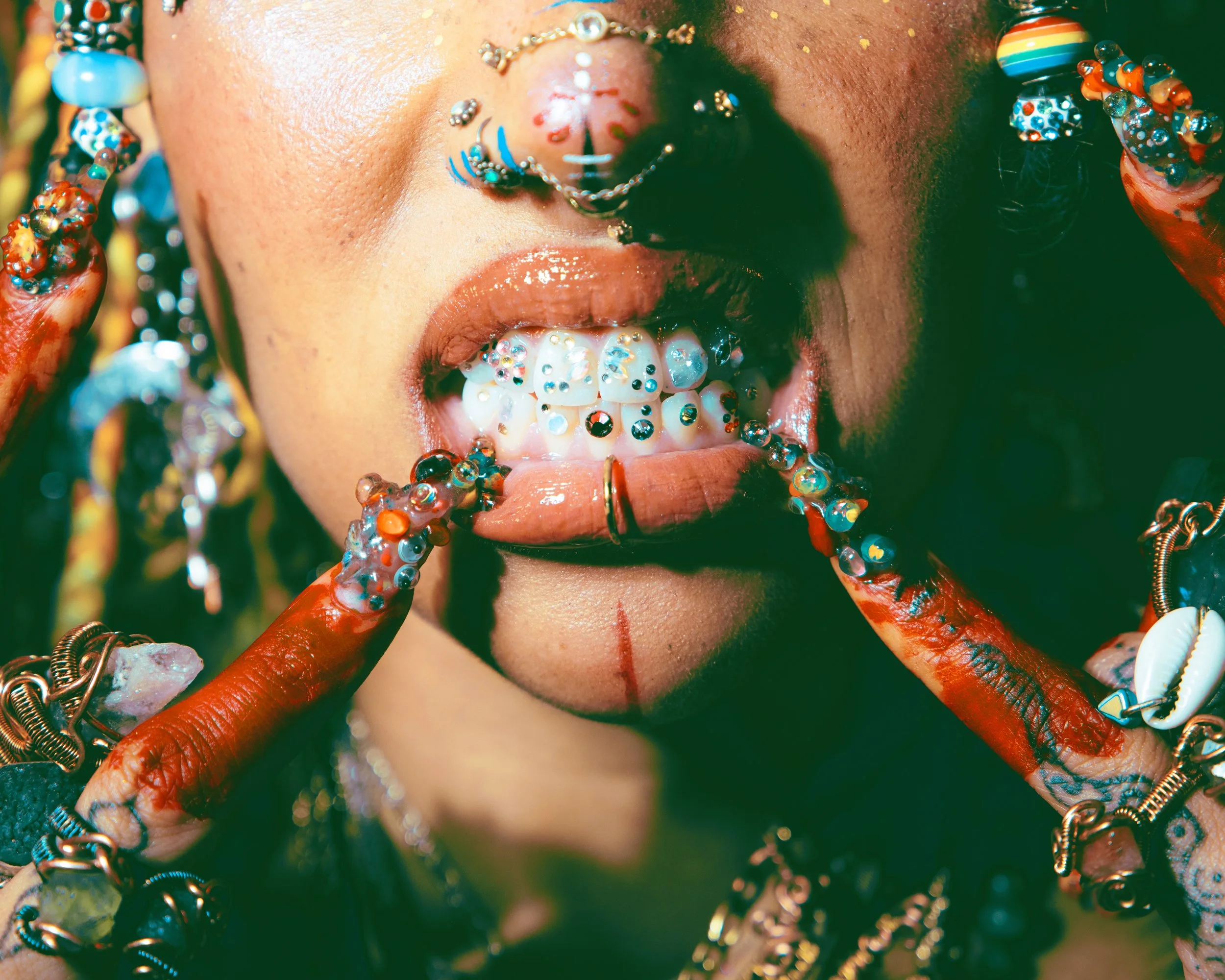 Local Dallas, Texas, DFW Non-traditional Fashion Editorial Creative Portraits Cover Art Photographer Photoshoot. Close-up of a person's face painted with colorful patterns, wearing jewelry, and surrounded by vibrant objects and accessories.