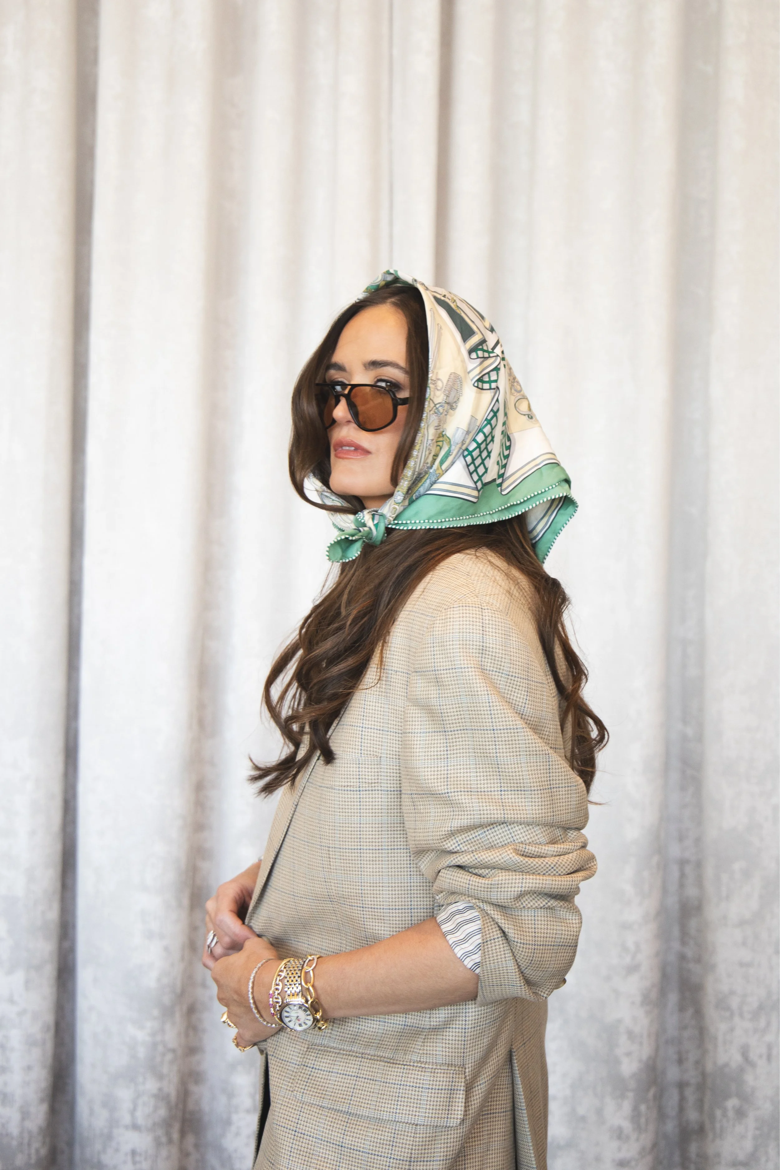 Local Dallas, Texas, DFW Non-traditional Fashion Editorial Creative Portraits Cover Art Photographer Photoshoot. Revel Workshop. A woman with long brown hair, wearing a beige checked blazer, dark sunglasses, a silk patterned scarf on her head, and va