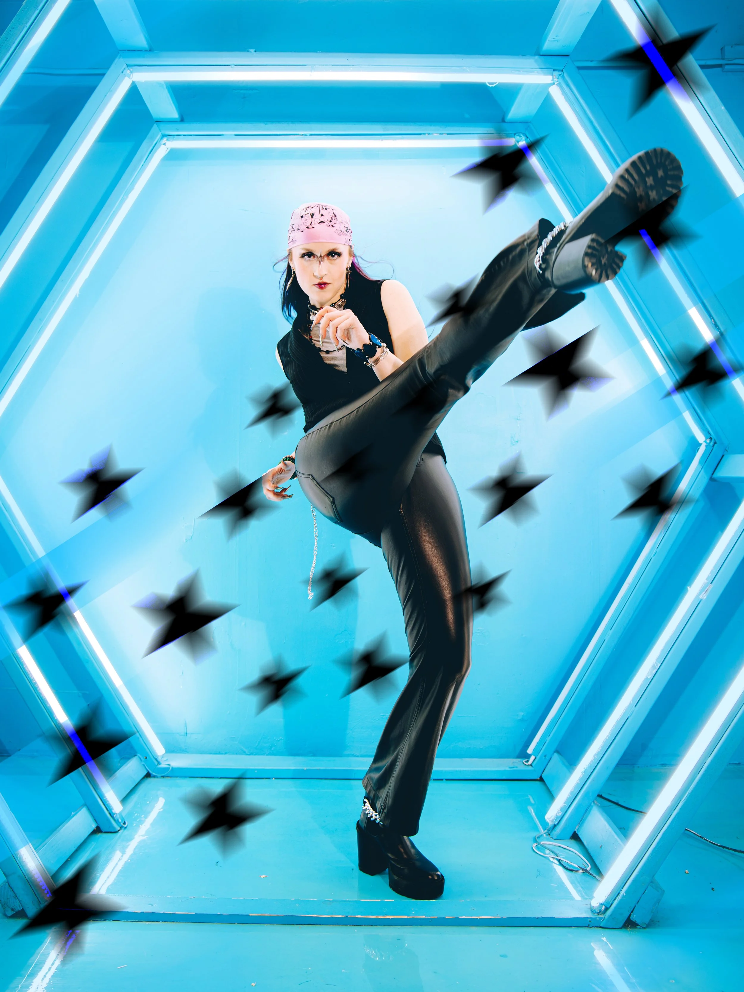 A woman with black hair, a pink bandana, and dark makeup strikes a confident pose in Local Dallas, Texas, DFW Non-traditional Editorial Creative Portraits Cover Art Photographer. a neon-lit, futuristic space with blue walls and fluorescent lighting. 