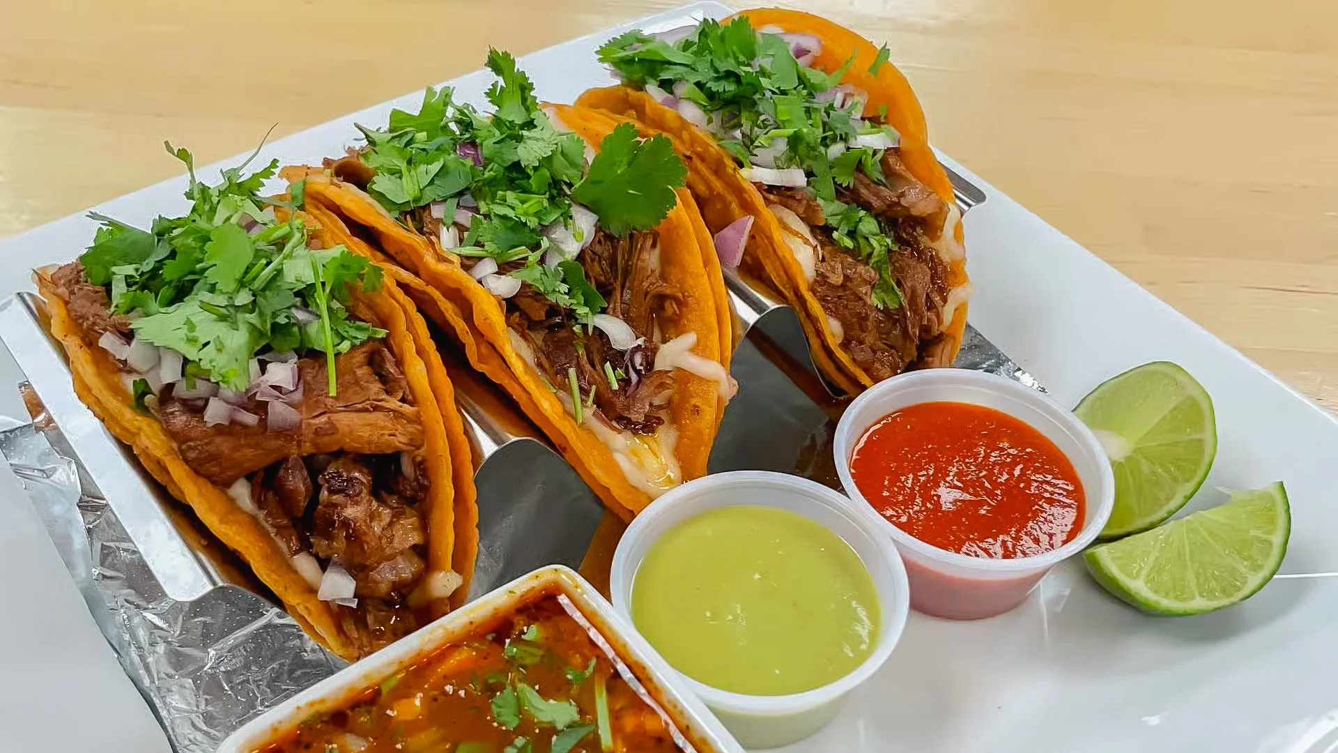 Tacos with lime wedges and red and green salsas at La Esquina Mexican Cafe in Jackson, MI
