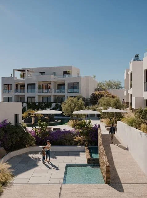 Modern apartment complex with outdoor pool, umbrellas, and landscaped greenery.