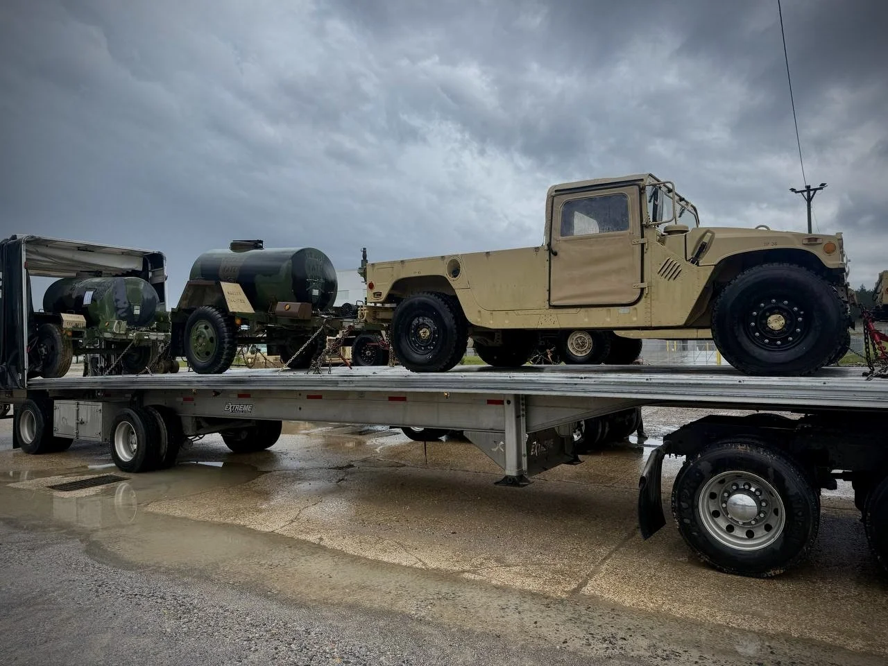 American Ground Lines flatbed transporting specialized military equipment.