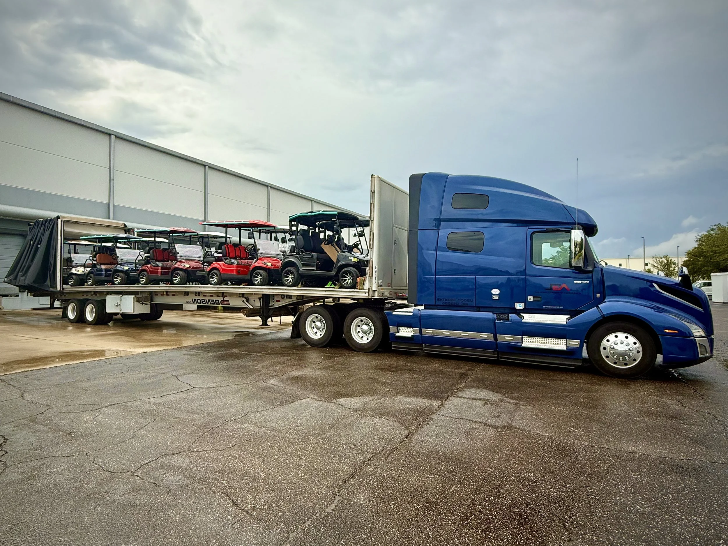 American Ground Lines truck hauling specialized freight on an open-deck trailer.