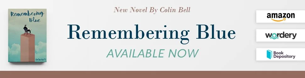 Book cover for "Remembering Blue" by Colin Bell, featuring a person sitting on top of a tall, pinkish-orange block against a cloudy blue sky, with text about the book being available now on Amazon, Wordery, and Book Depository.