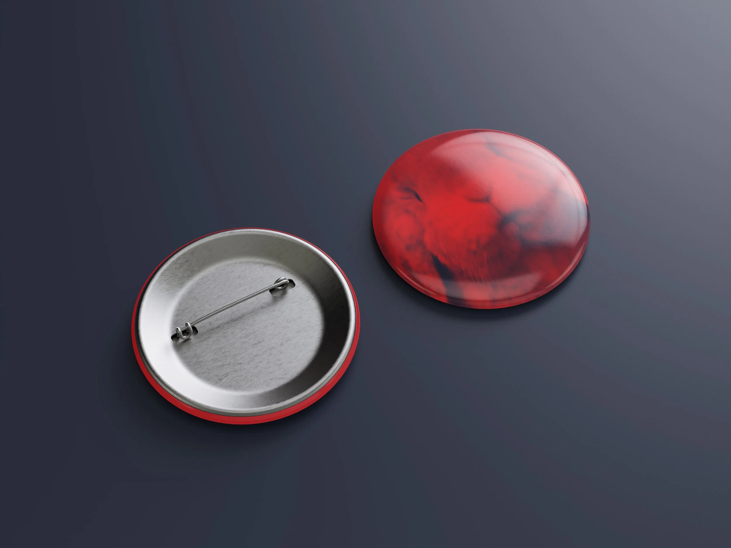 Behind view of two vintage-style push buttons, one silver and one red, placed on a dark surface. The silver button shows the back with the hinge and spring, while the red button has a marbled design on the top.
