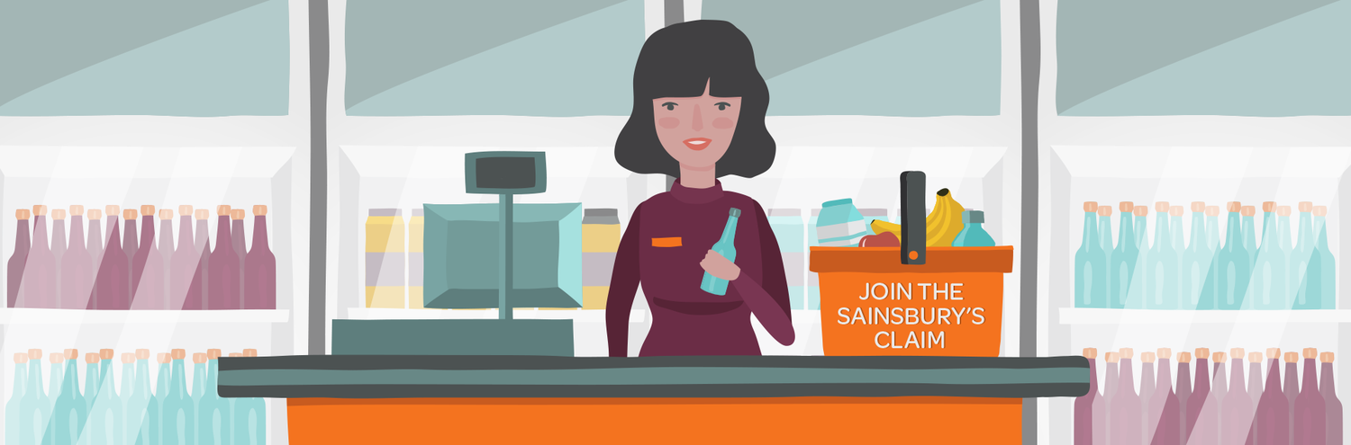 A woman working as a cashier at a store checkout counter with shelves of bottles behind her and a sign that says 'Join the Sainsbury's Claim' on the counter.