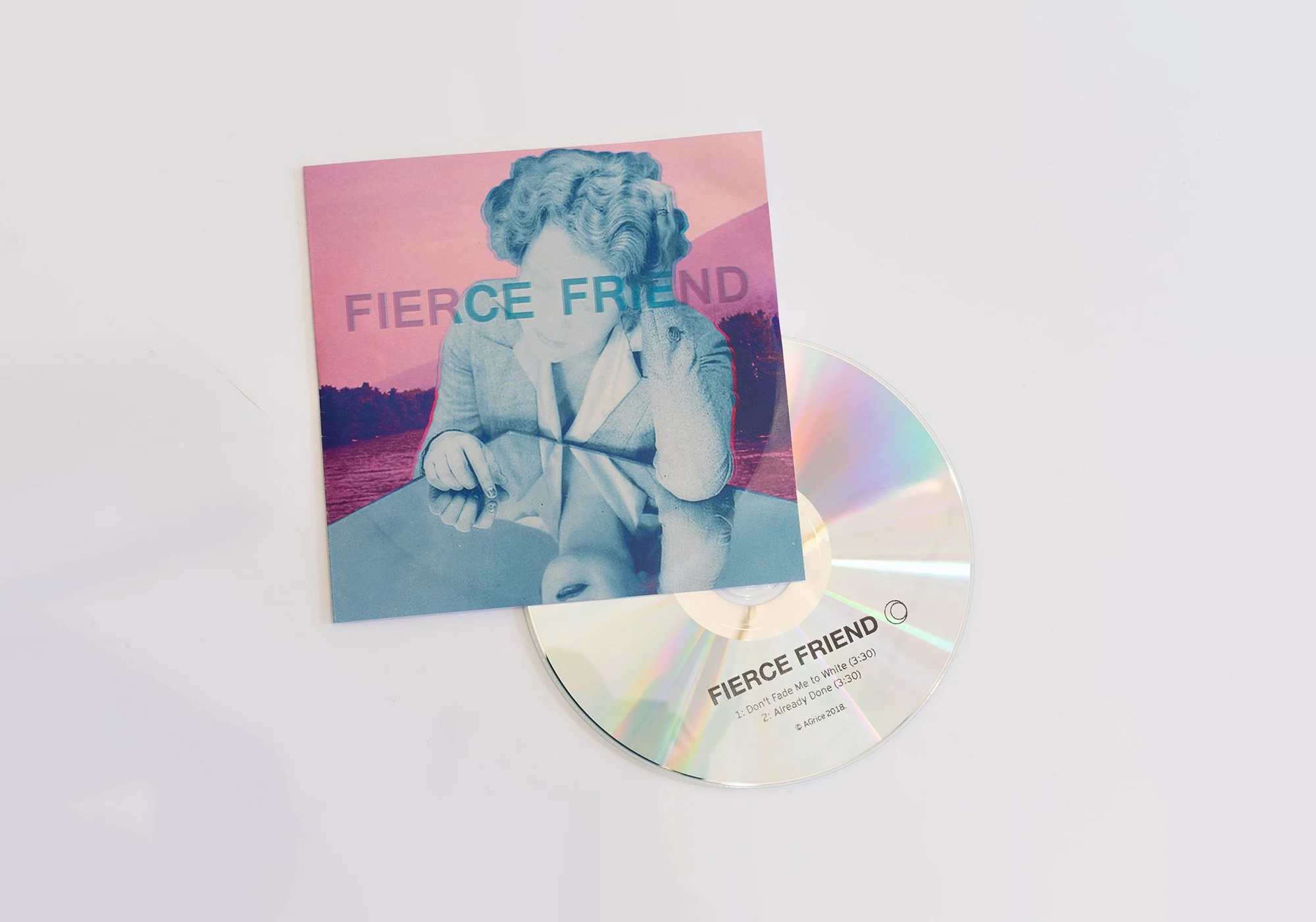 An album cover titled 'FIERCE FRIEND' featuring a stylized portrait of a woman with wavy hair, sitting at a table with her chin resting on her hand, and a landscape with a sunset in the background. There is also a CD with the same title and track lis