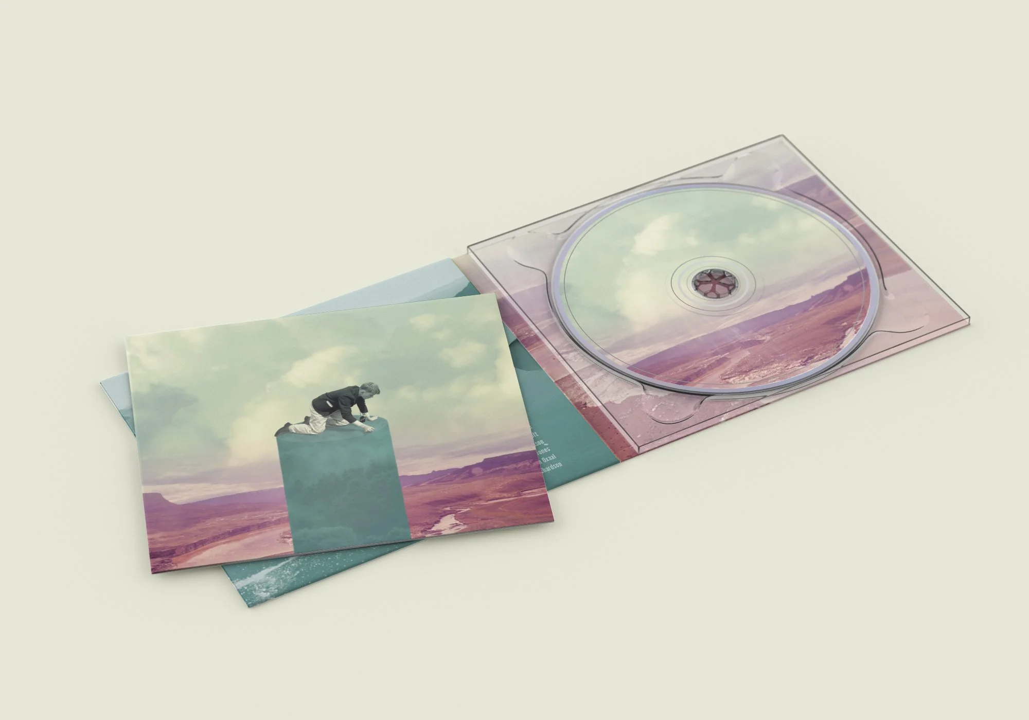 CD case with landscape artwork and photograph of a person on a block, with additional printed images of landscapes.
