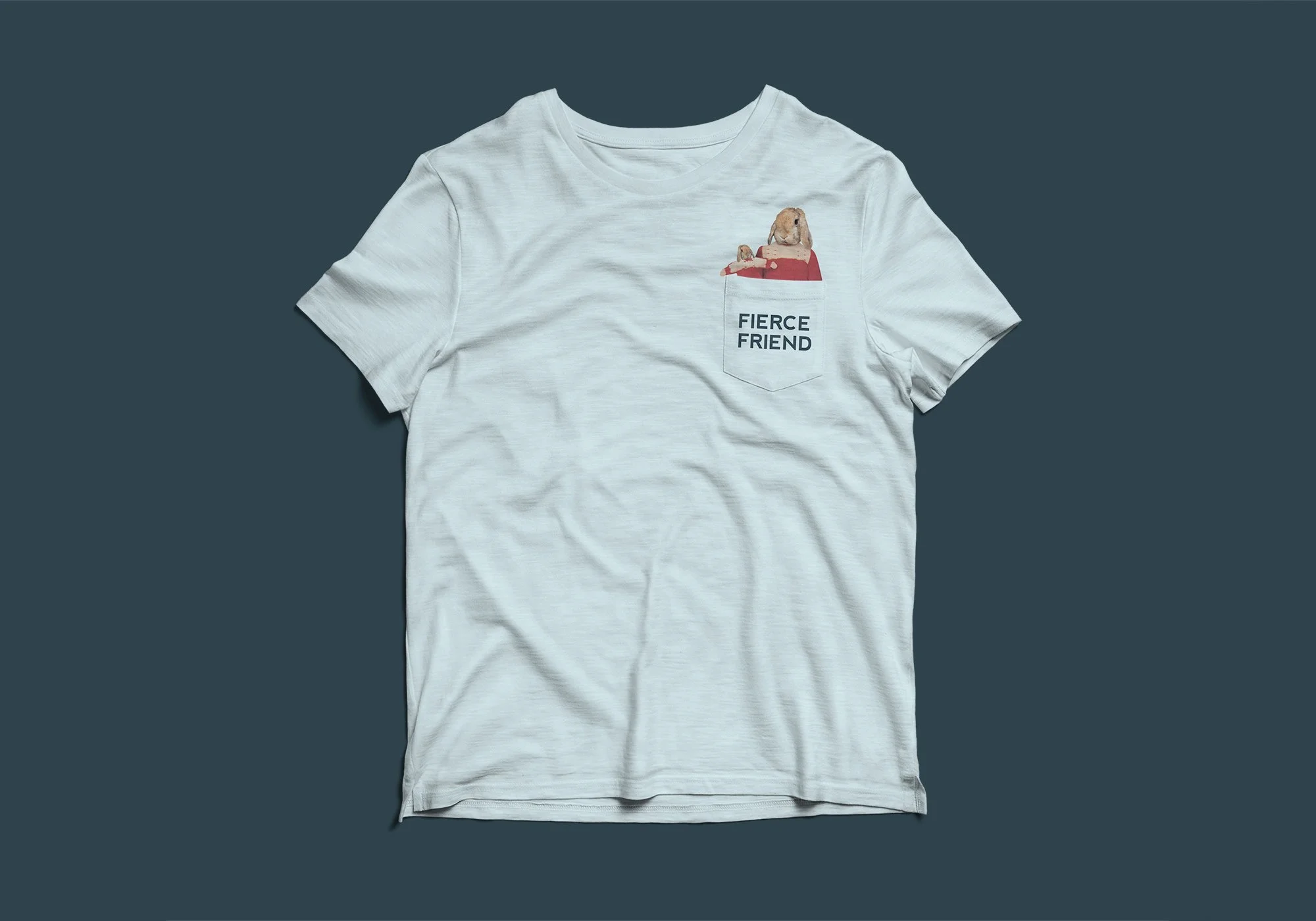 White T-shirt with a pocket on the left chest featuring a rabbit with long ears, and the text 'FIERCE FRIEND' below the rabbit.