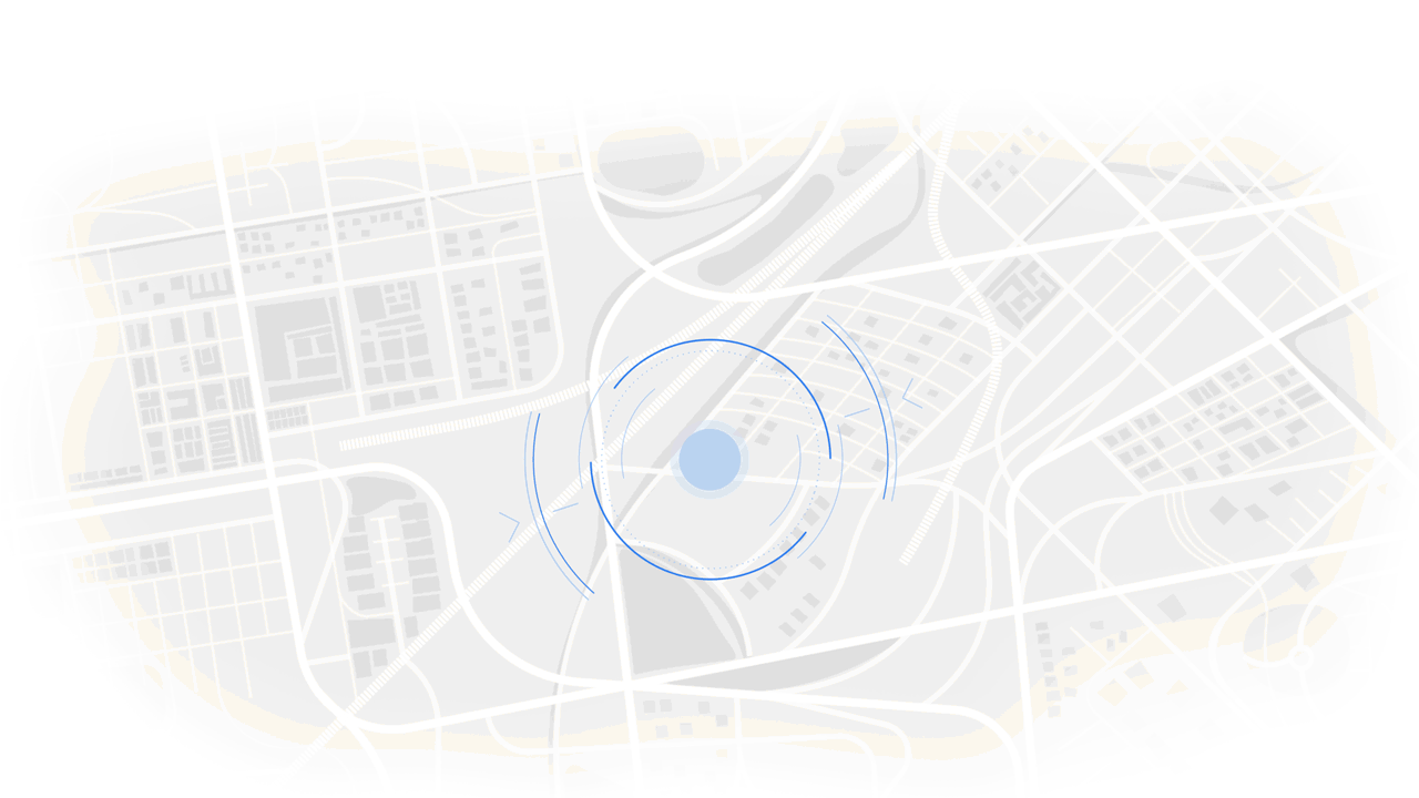Digital map with a blue circle indicating location, surrounded by concentric rings, overlaid on an urban layout with streets and buildings.