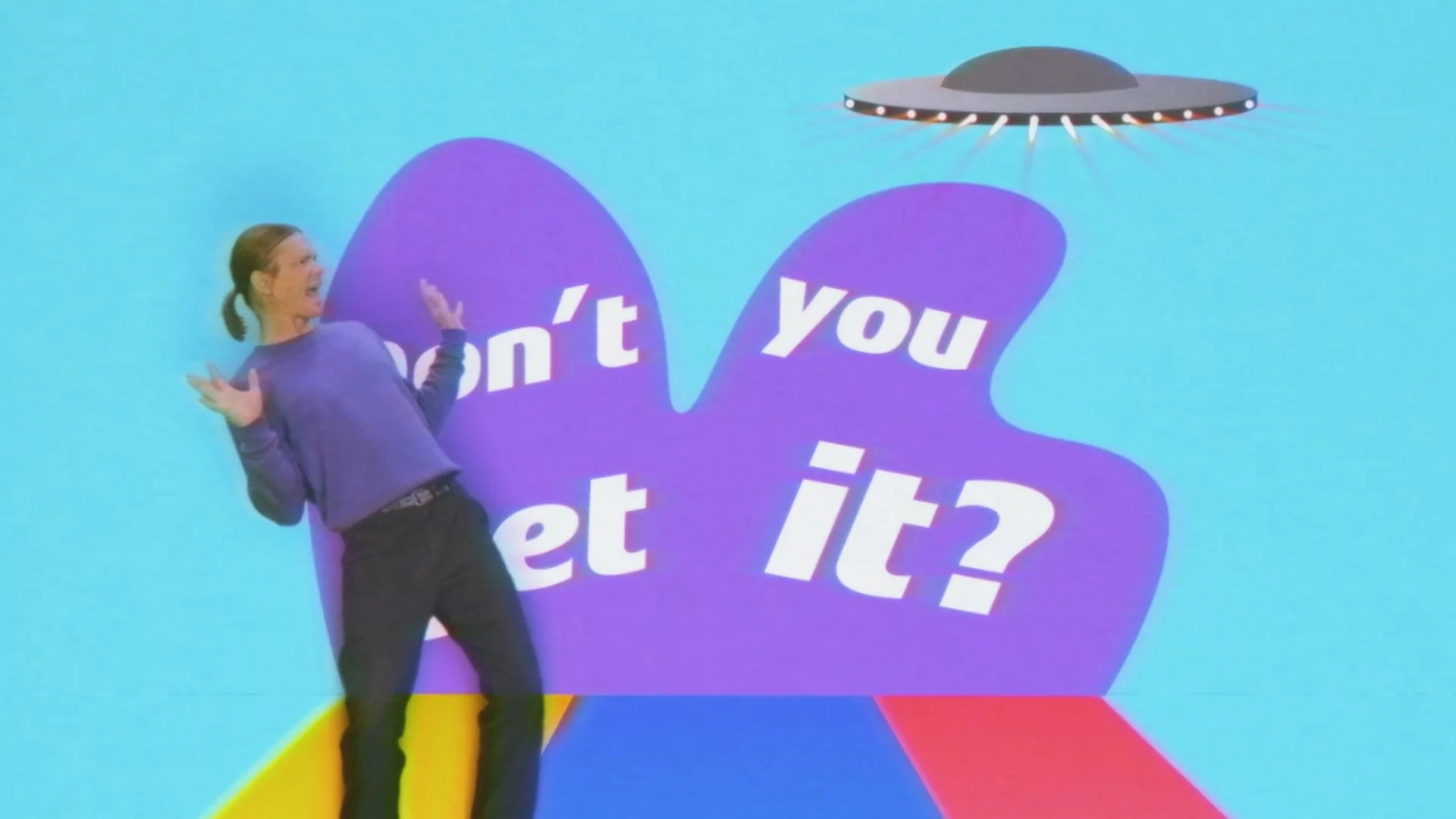 A person with long brown hair in a ponytail, wearing a purple long-sleeve shirt and black pants, standing in front of a blue background with a large purple shape and white text that reads 'can't you get it?' There is a flying saucer above the shape e