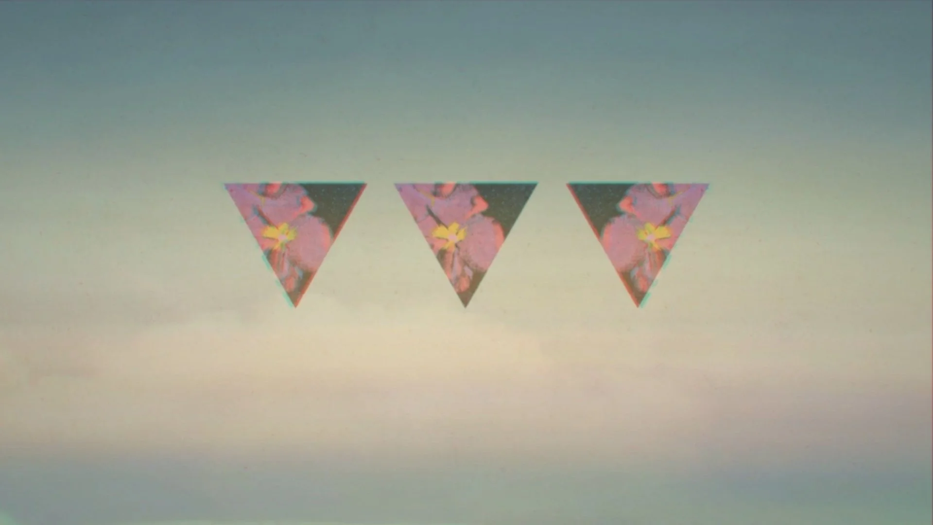 Three floral patterned triangles with a galaxy background hanging in a row.