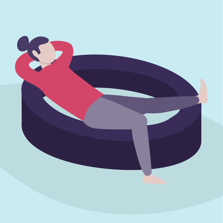 A woman relaxing in an inflatable pool in a room with light blue walls.