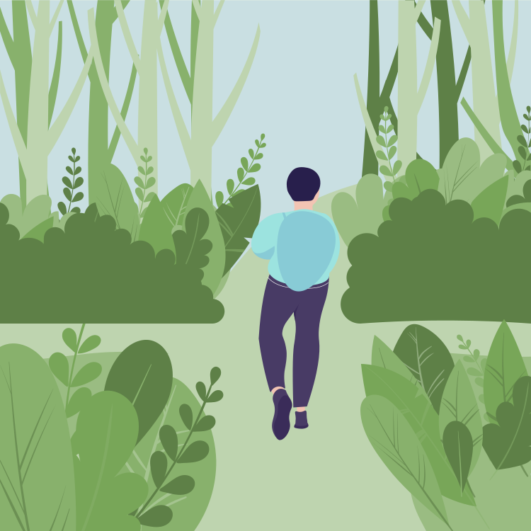 A person walking through a lush green garden or park with tall trees and dense foliage.