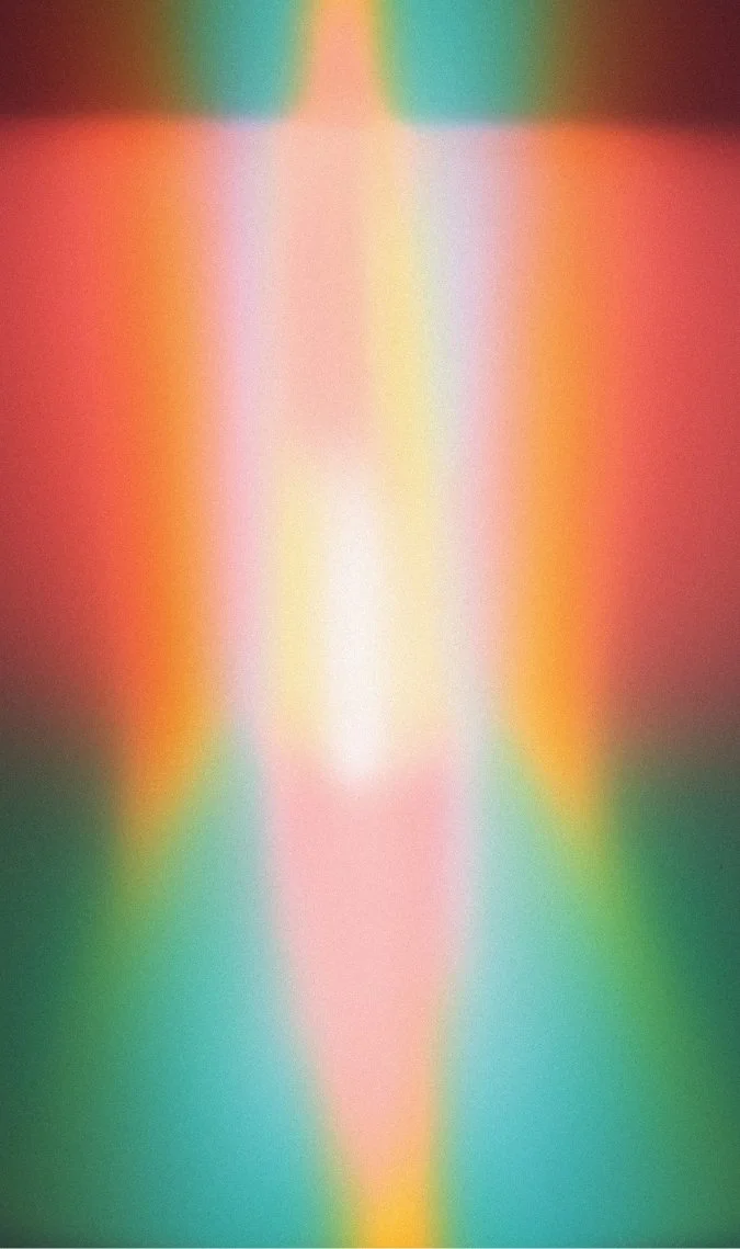 Blurred rainbow-colored abstract pattern with vertical symmetry and soft gradients.