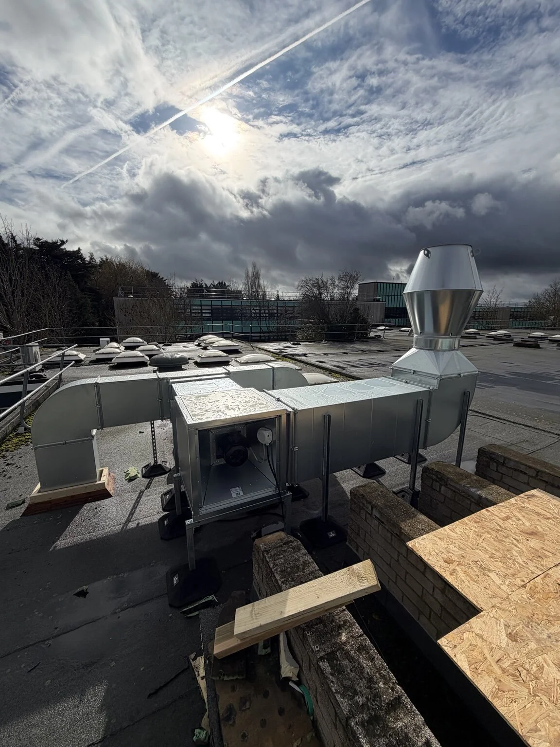 Electrical installation and maintenance work on commercial rooftop HVAC equipment.