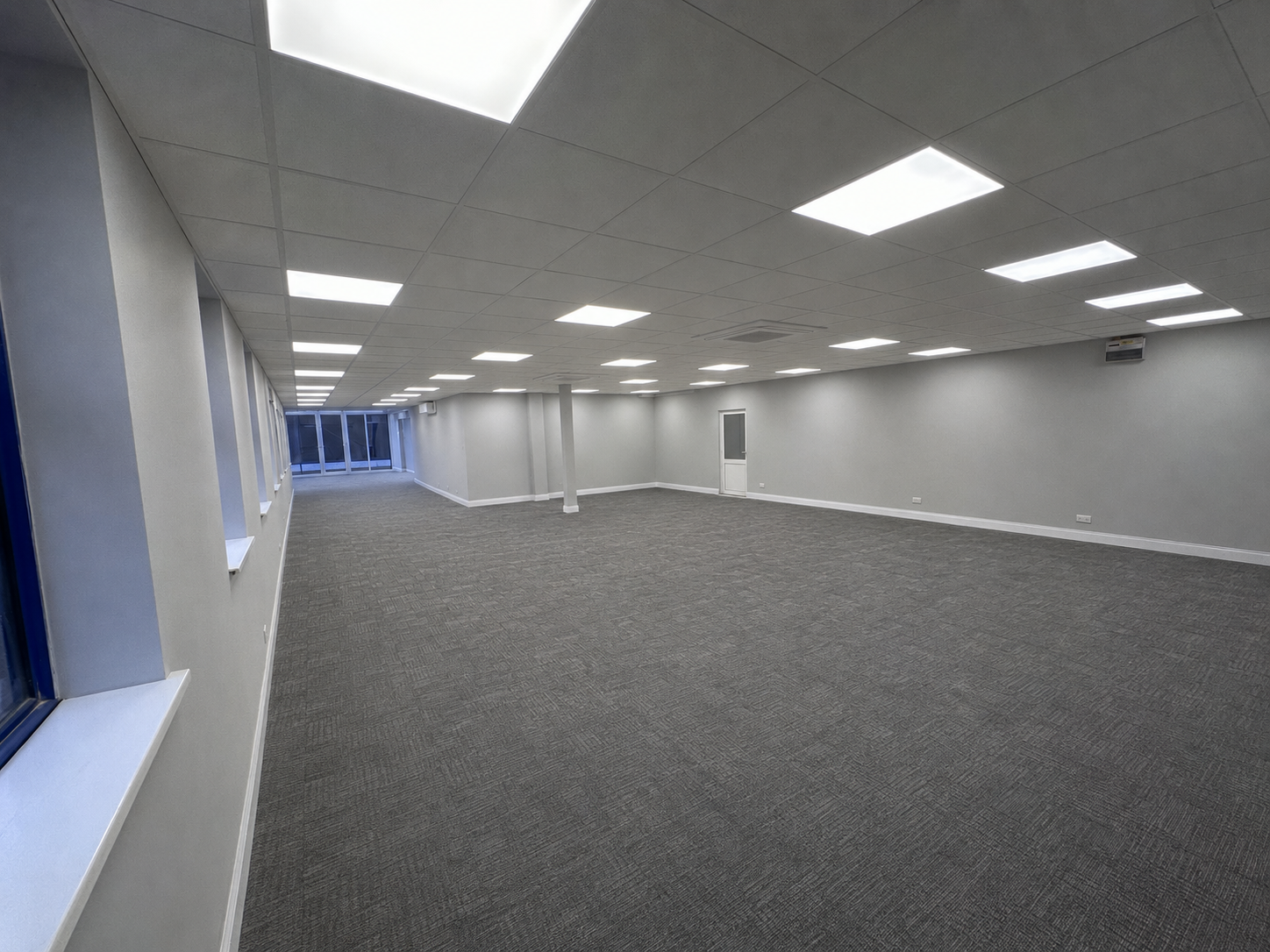     Completed commercial office LED lighting installation with ceiling panels.