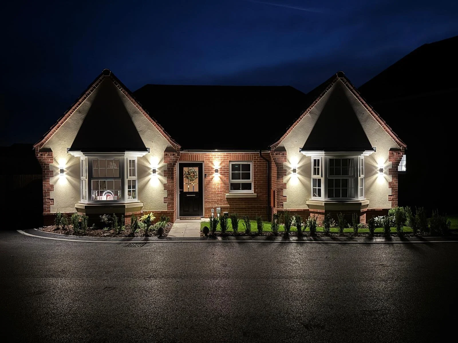    Completed exterior lighting installation illuminating the front of a house.