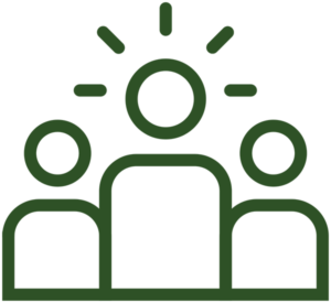 Icon of three human figures behind a table or desk, representing a team or group meeting.