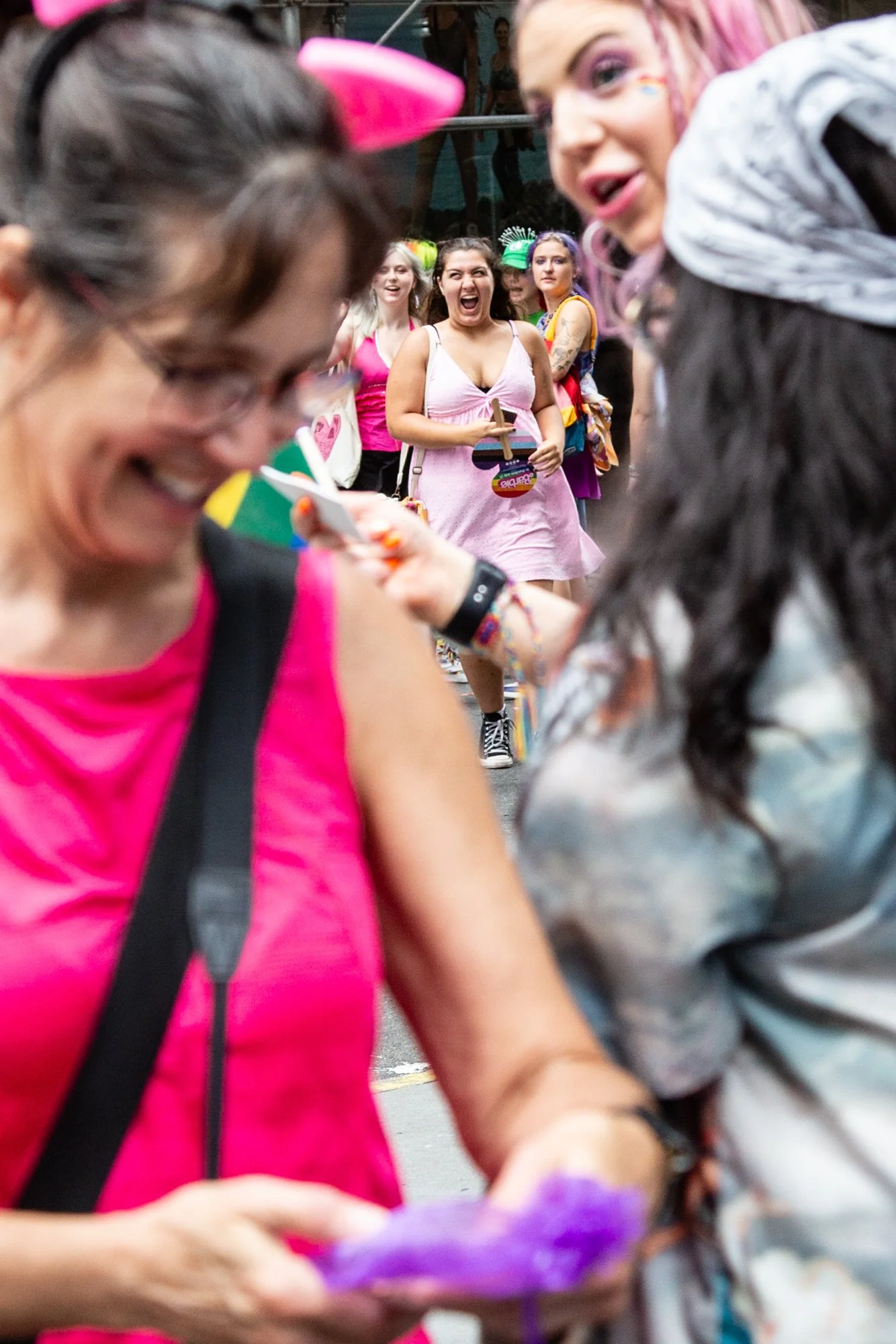 Colorfully dressed crowd celebrating at a lively outdoor parade