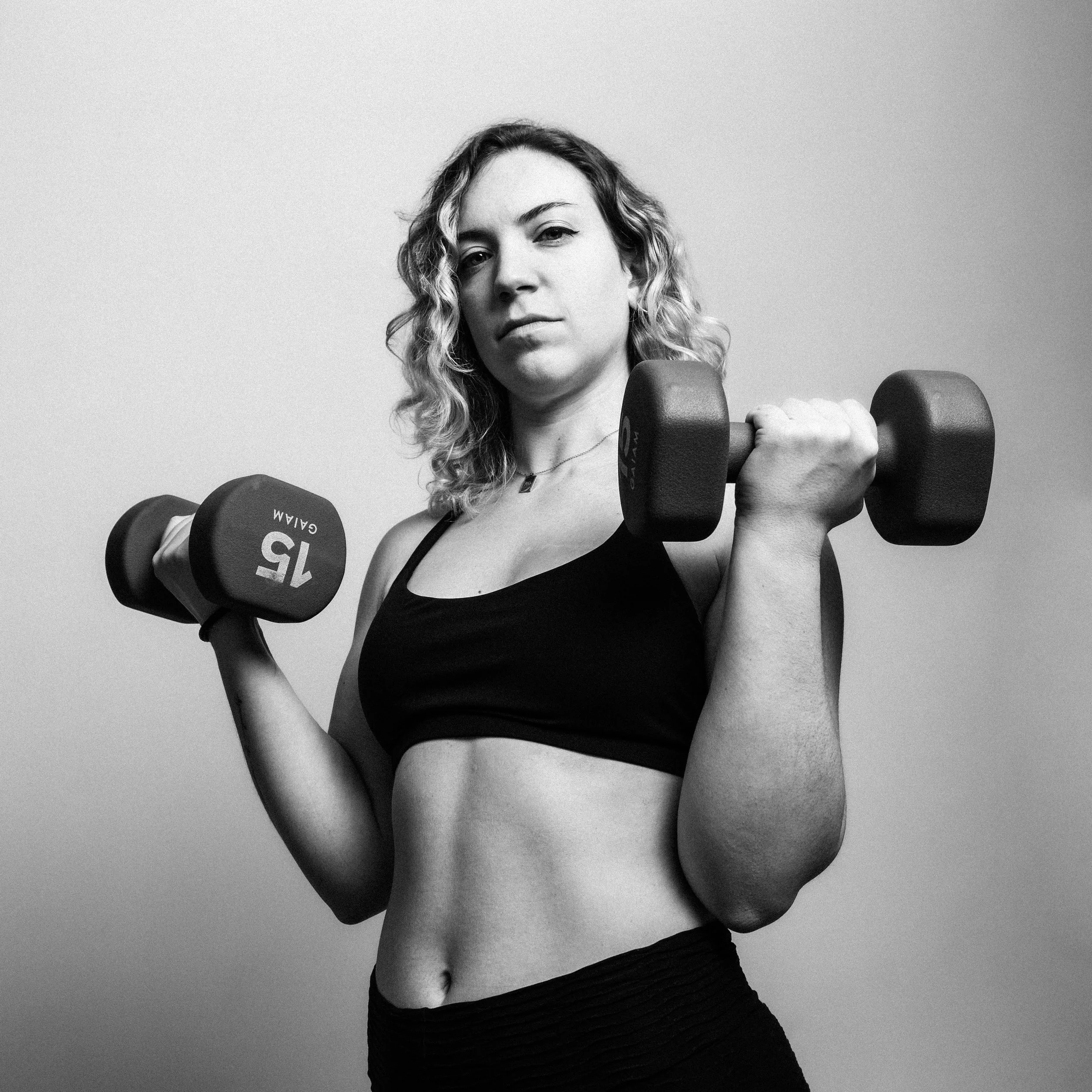 Black and white photo of a strong woman working out. 