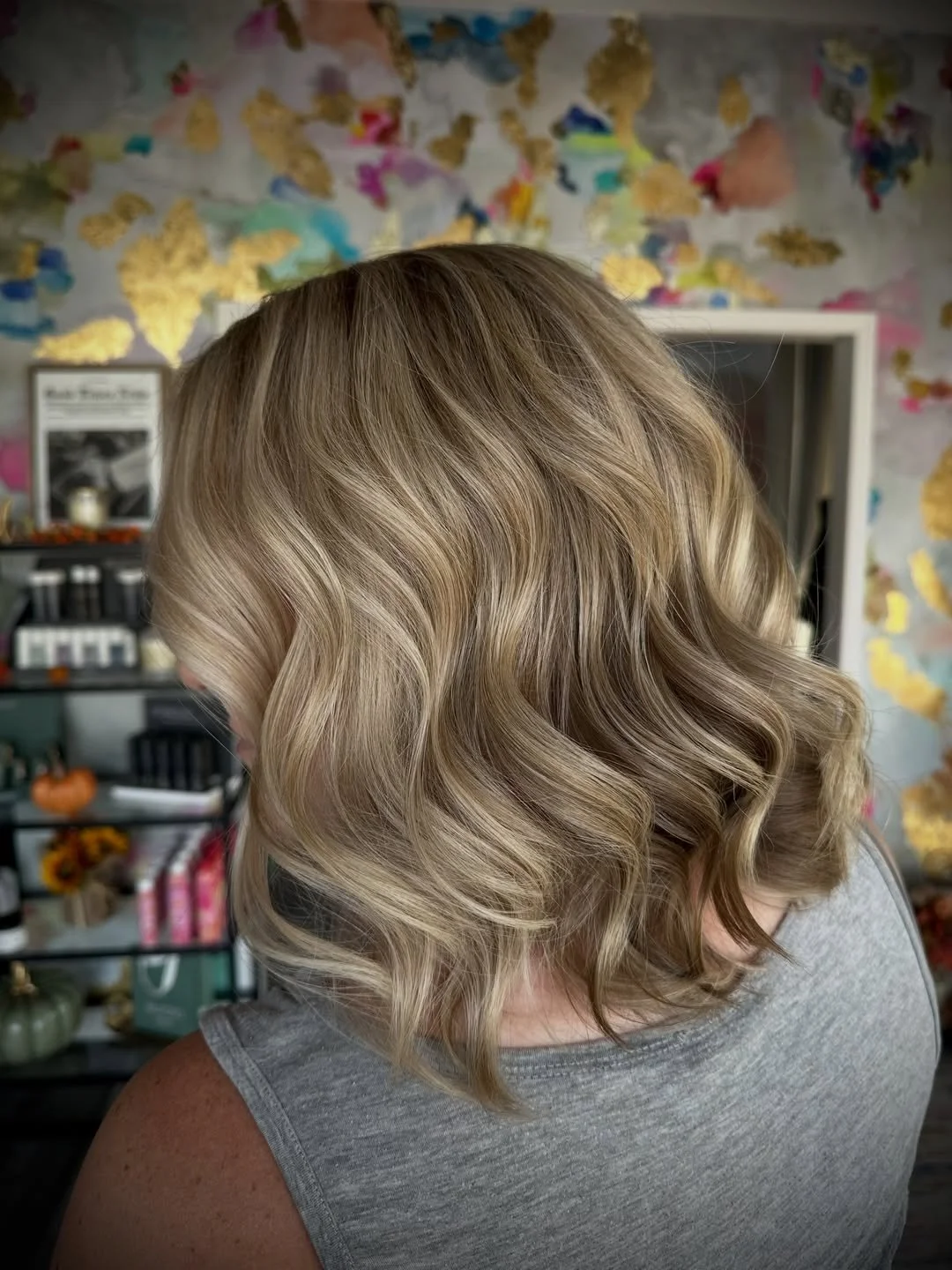 A woman with shoulder-length, blonde, wavy hair.