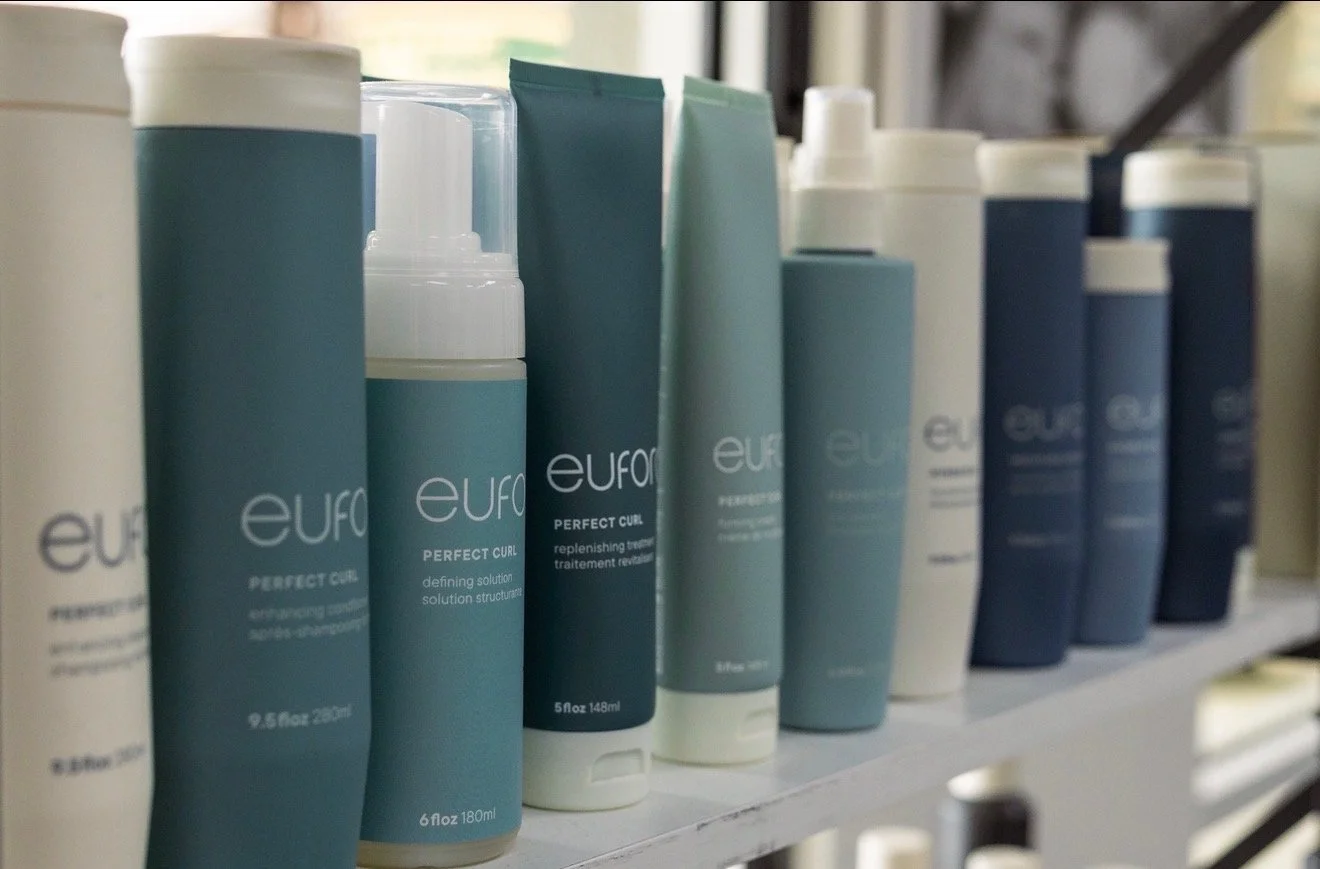 Shelf with various tubes and bottles of hair care products labeled Eurol.