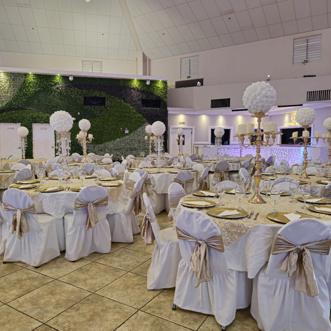 Crystal Palace Ballroom reception setup with round tables, white chair covers, and elegant centerpieces.