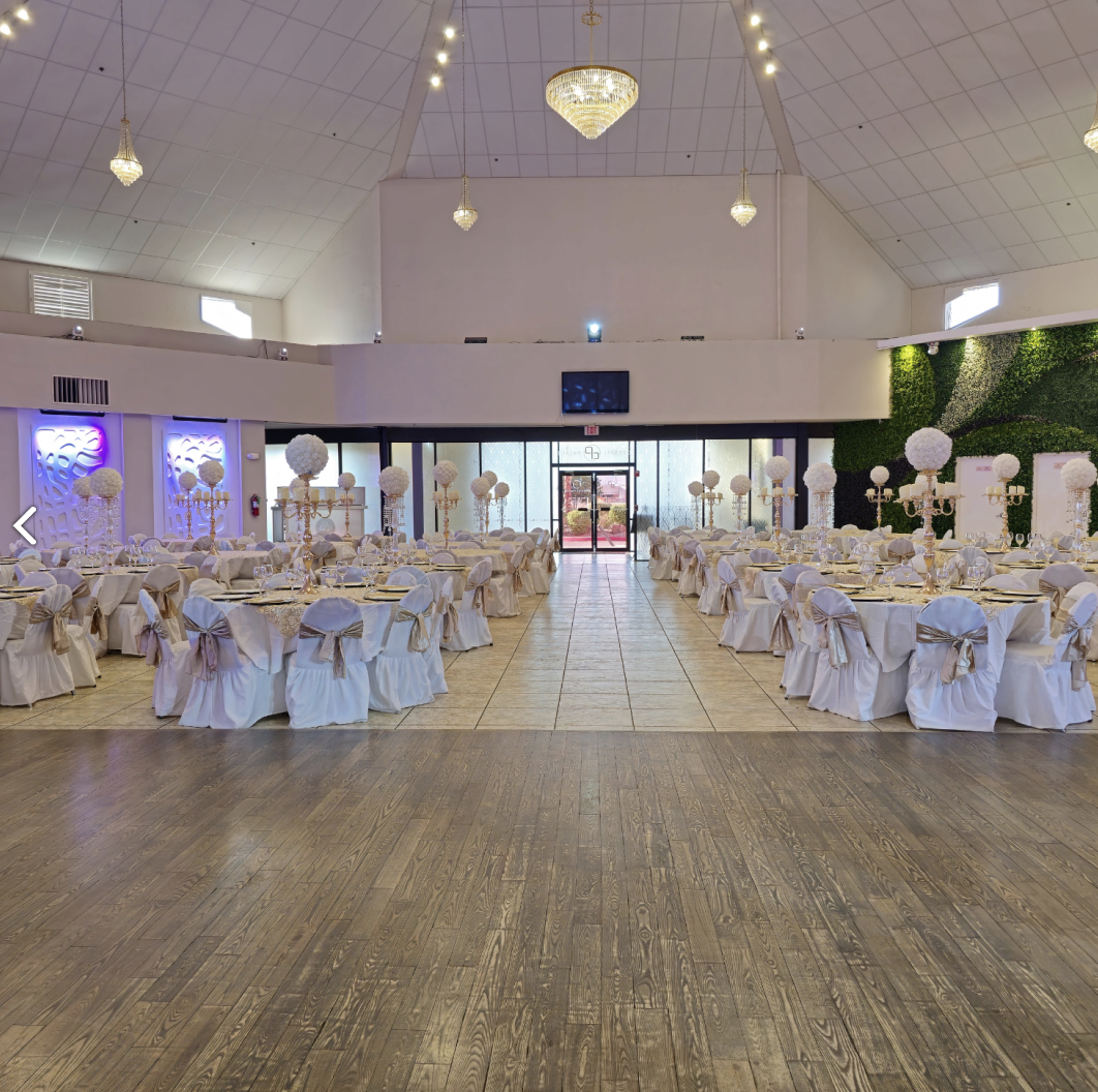 Spacious Crystal Palace Ballroom with round tables, white linens, and an open dance floor.